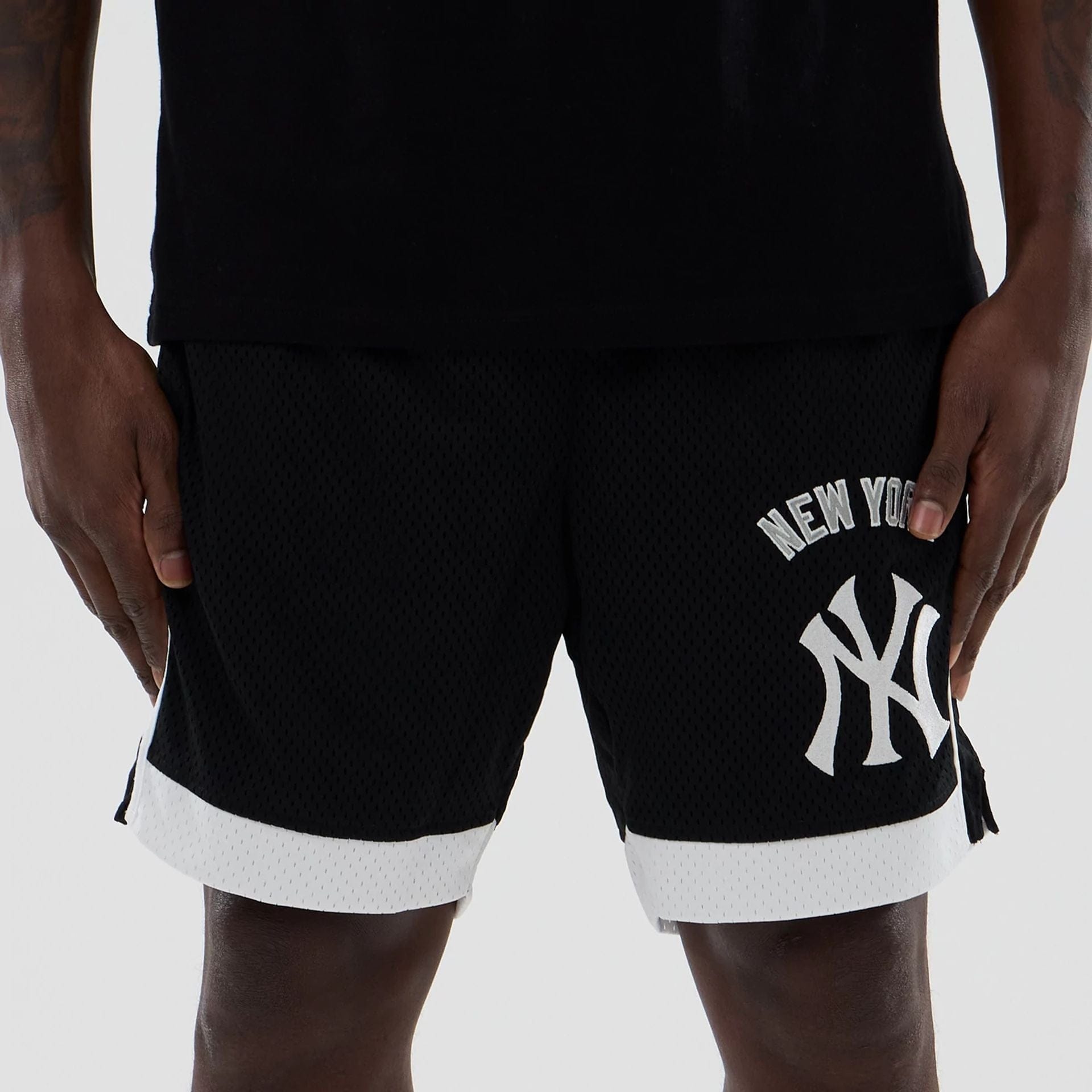 The model is wearing these MLB New York Yankees Mesh Shorts in black. 2