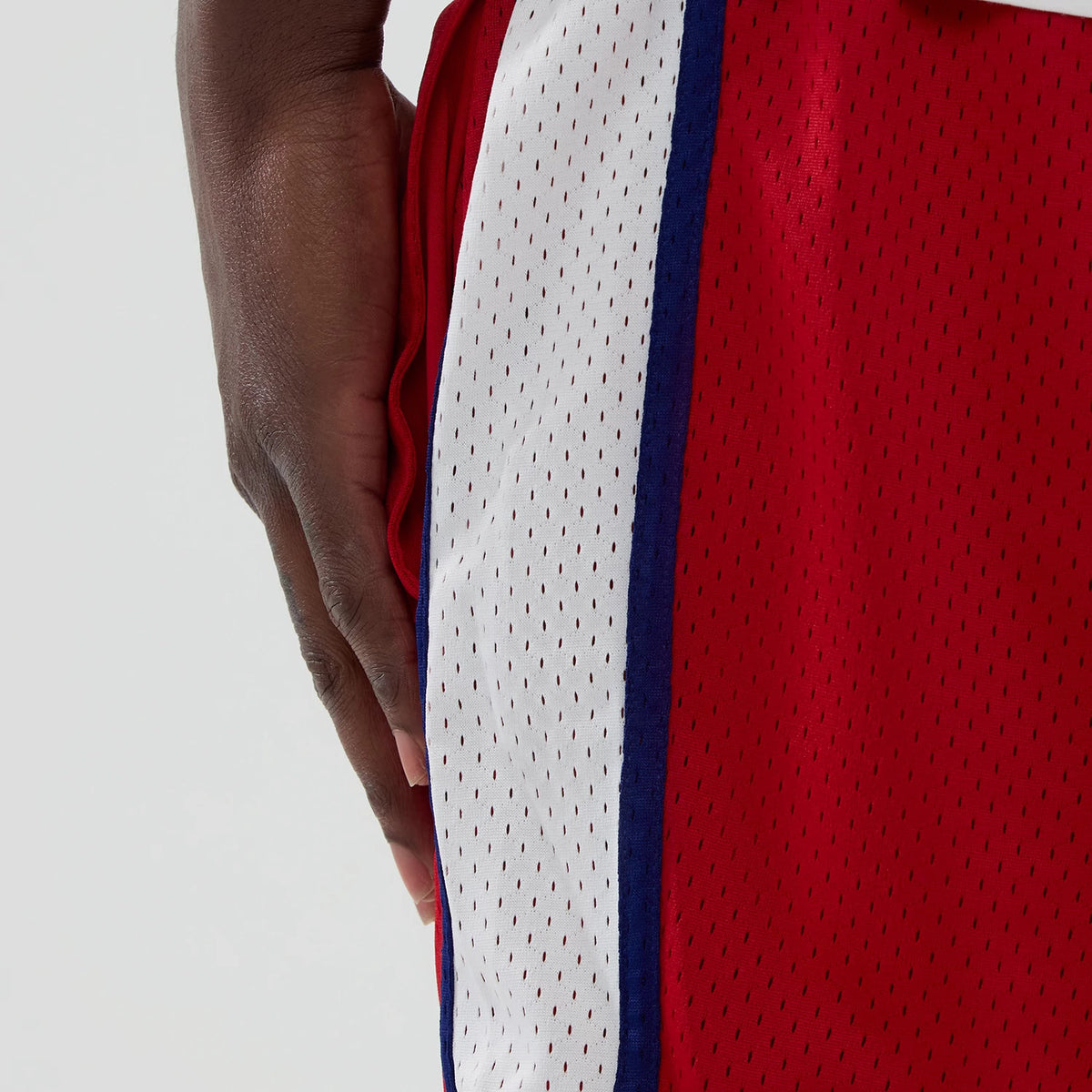 New Era Philadelphia Phillies MLB Red Mesh Shorts, side view showing the red mesh fabric with a vertical white and blue stripe on the side, emphasised by small perforations along the entire length.