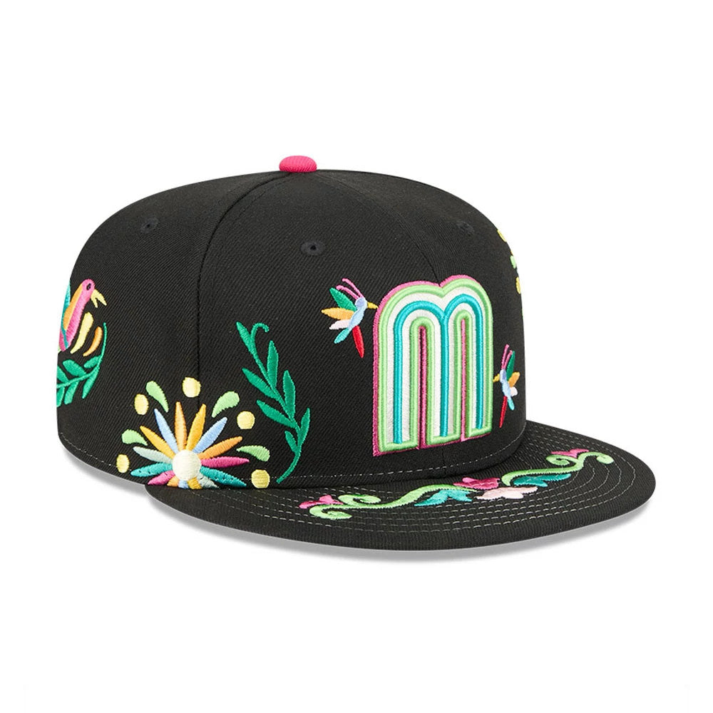 Mexico WBC Latin Embroidery Black New Era 59FIFTY Fitted Cap, front view showing a colourful embroidered letter M on the front panel, with floral and bird embroidery on the black visor and crown, and a pink top button.