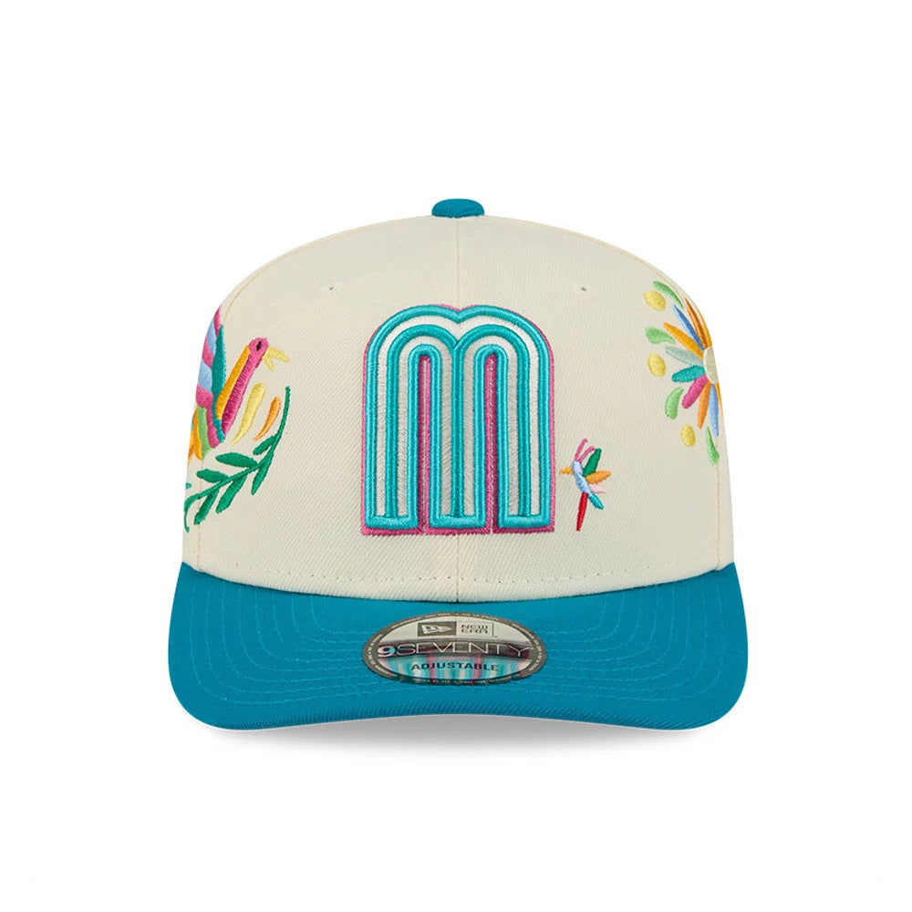 Mexico WBC Latin Embroidery White New Era 9SEVENTY Stretch Snap Adjustable Cap, front view showing a large M logo in teal and pink raised embroidery on the white crown, surrounded by colourful Mexican-themed embroidery, with a teal visor.