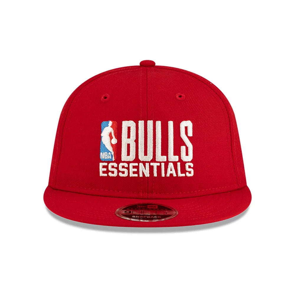 Chicago Bulls FOG x NBA Red Retro Crown New Era 9FIFTY Adjustable Cap, front view showing the white and blue NBA Bulls Essentials lettering embroidered on the red front panel with eyelets, flat visor, and a 9FIFTY size sticker underneath.