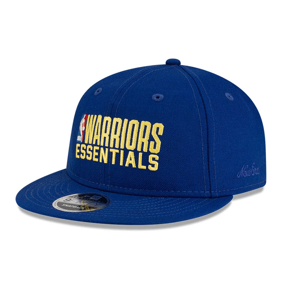 Golden State Warriors FOG x NBA Blue Retro Crown New Era 9FIFTY Adjustable Cap, three-quarter view with raised yellow Warriors Essentials embroidery on the front panel, blue flat visor with 9FIFTY size sticker, and New Era script on the left side.