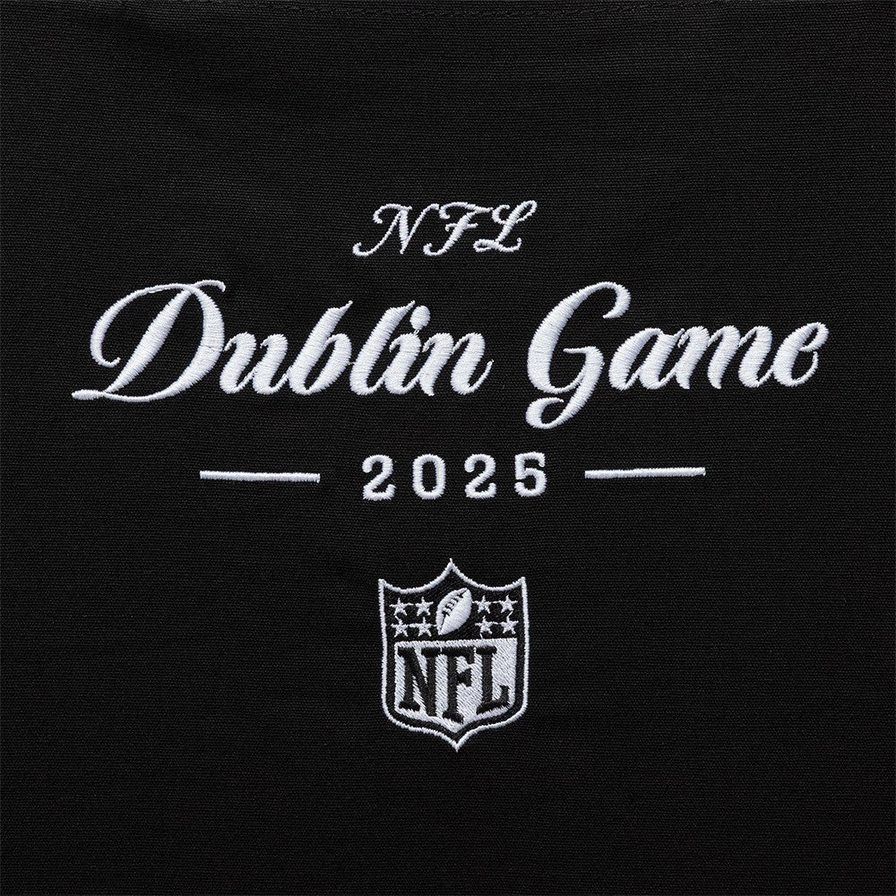 New Era Shield Logo NFL Dublin Game 2025 Black Tote Bag, front view showing the white embroidered lettering Dublin Game 2025 beneath NFL and above the shield logo with stars and a football, all centred on the black surface.