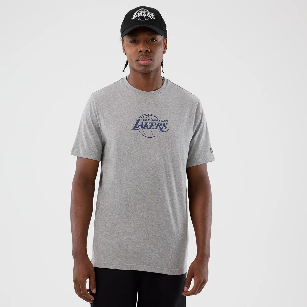 New Era LA Lakers NBA Back To School Grey T-Shirt, front view on-model showing the blue Los Angeles Lakers logo printed across the chest, short sleeves and a relaxed fit, paired with a black cap featuring a matching embroidered logo.