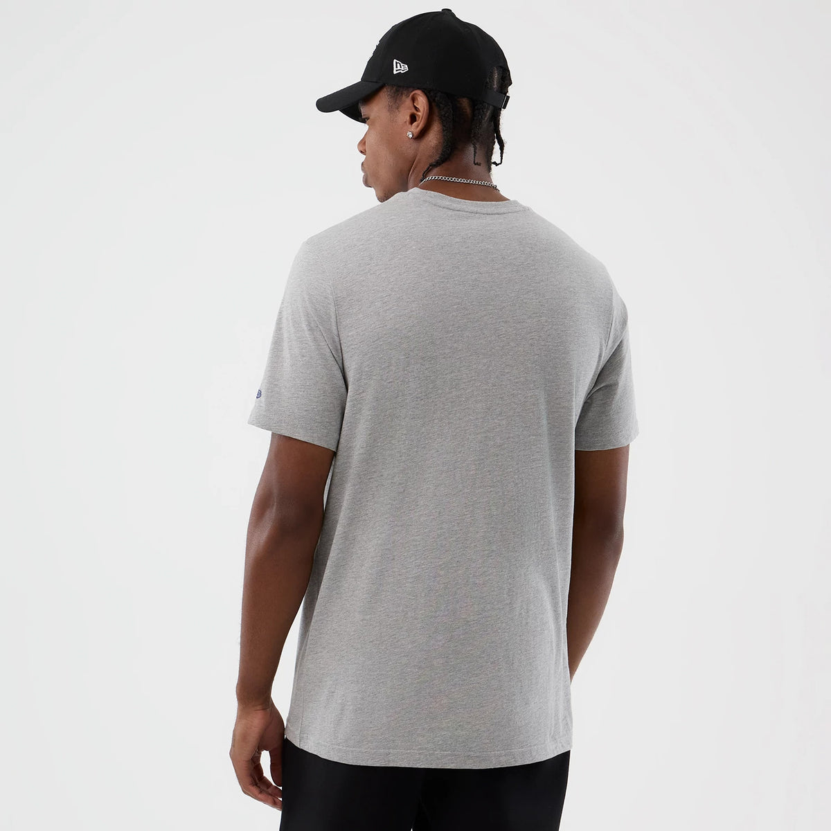 New Era LA Lakers NBA Back To School Grey T-Shirt, back view on-model highlighting the plain grey fabric with no graphics, worn with a black New Era cap featuring an embroidered logo on the side.