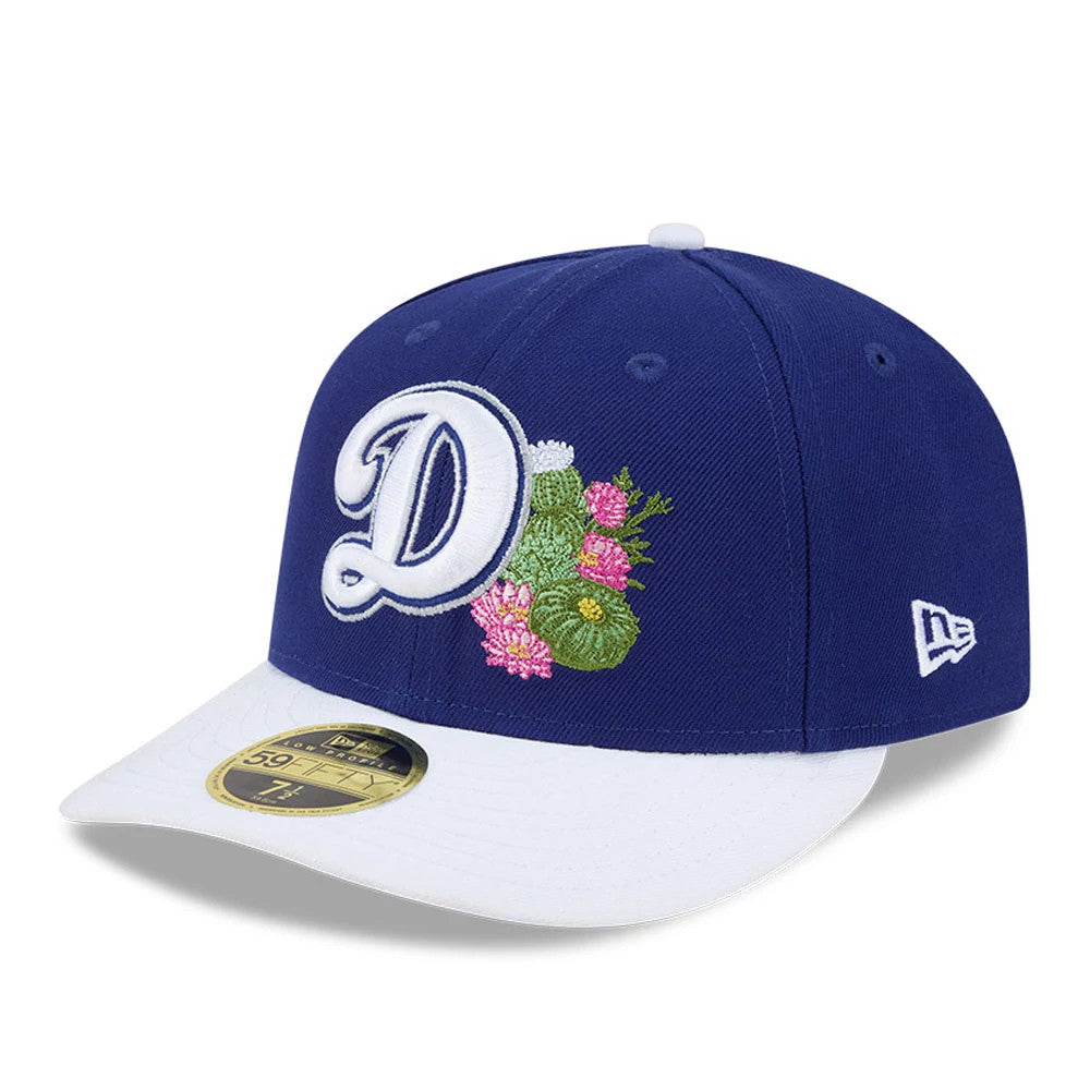 LA Dodgers MLB Spring Training 2026 Blue Low Profile New Era 59FIFTY Fitted Cap, three-quarter view showing the white raised embroidered D logo with green and pink floral accents on the soft blue crown, with a white curved visor.