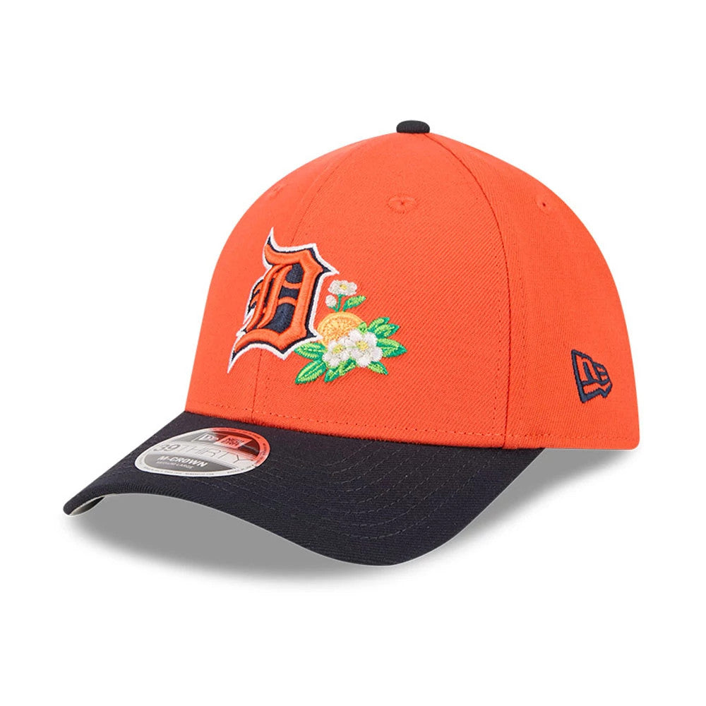 Tigers MLB Spring Training 2026 Orange New Era 39THIRTY M-Crown Stretch Fit Cap, front view showing an orange and navy embroidered D logo with floral accents on the front panel, black curved visor, and 39THIRTY size sticker.
