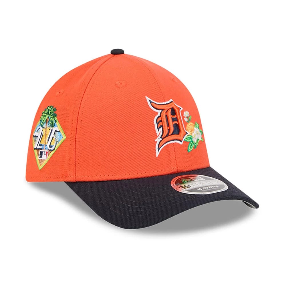 Tigers MLB Spring Training 2026 Orange New Era 39THIRTY M-Crown Stretch Fit Cap, three-quarter view showing embroidered orange and white floral D logo on the front and a colourful diamond patch on the right side.