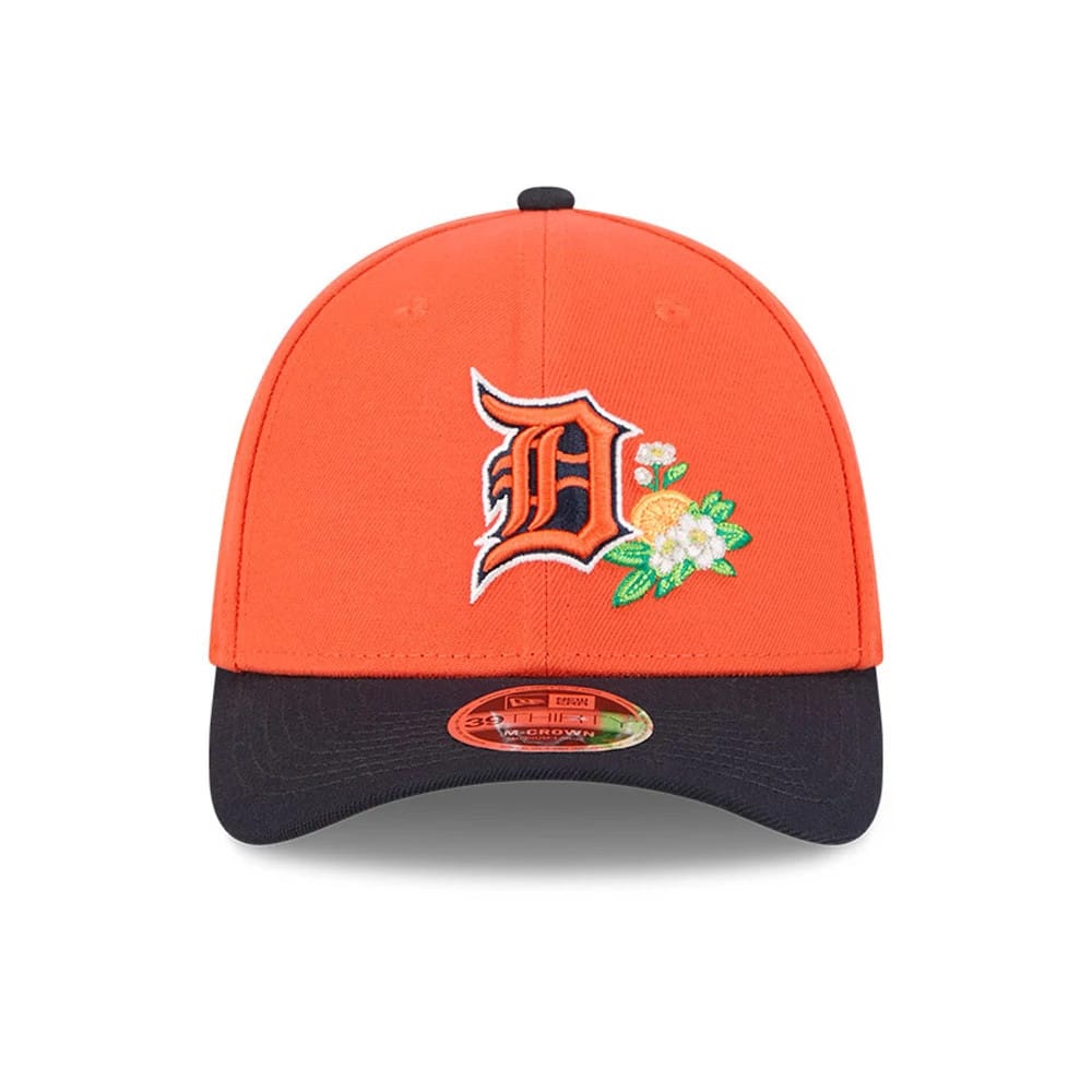Tigers MLB Spring Training 2026 Orange New Era 39THIRTY M-Crown Stretch Fit Cap, front view showing the orange crown with embroidered Tigers logo and floral details, navy curved visor with 39THIRTY size sticker.