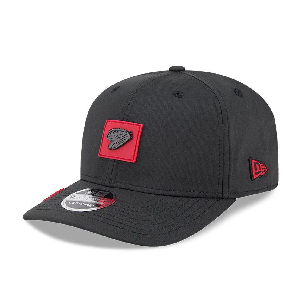 Fresno Grizzlies MiLB Clubhouse Black New Era 9SEVENTY Stretch Snap Adjustable Cap, three-quarter view showing a red embroidered bear logo on the front panel, black visor with a 9SEVENTY size sticker and red New Era flag logo on the left side.