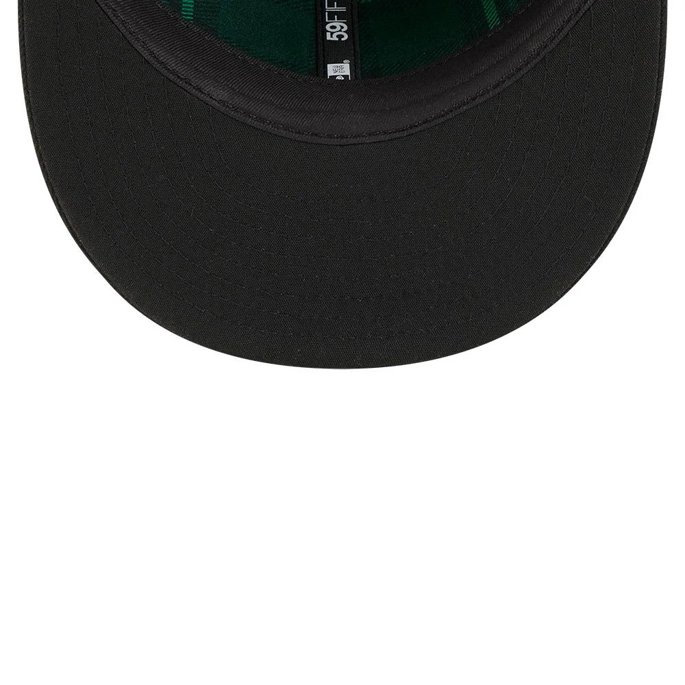 Miami Marlins MLB Saint Patrick's Day Black New Era 59FIFTY Fitted Cap, inside view showing green undervisor, black sweatband with New Era branding, and green taping along the seams inside the structured crown.