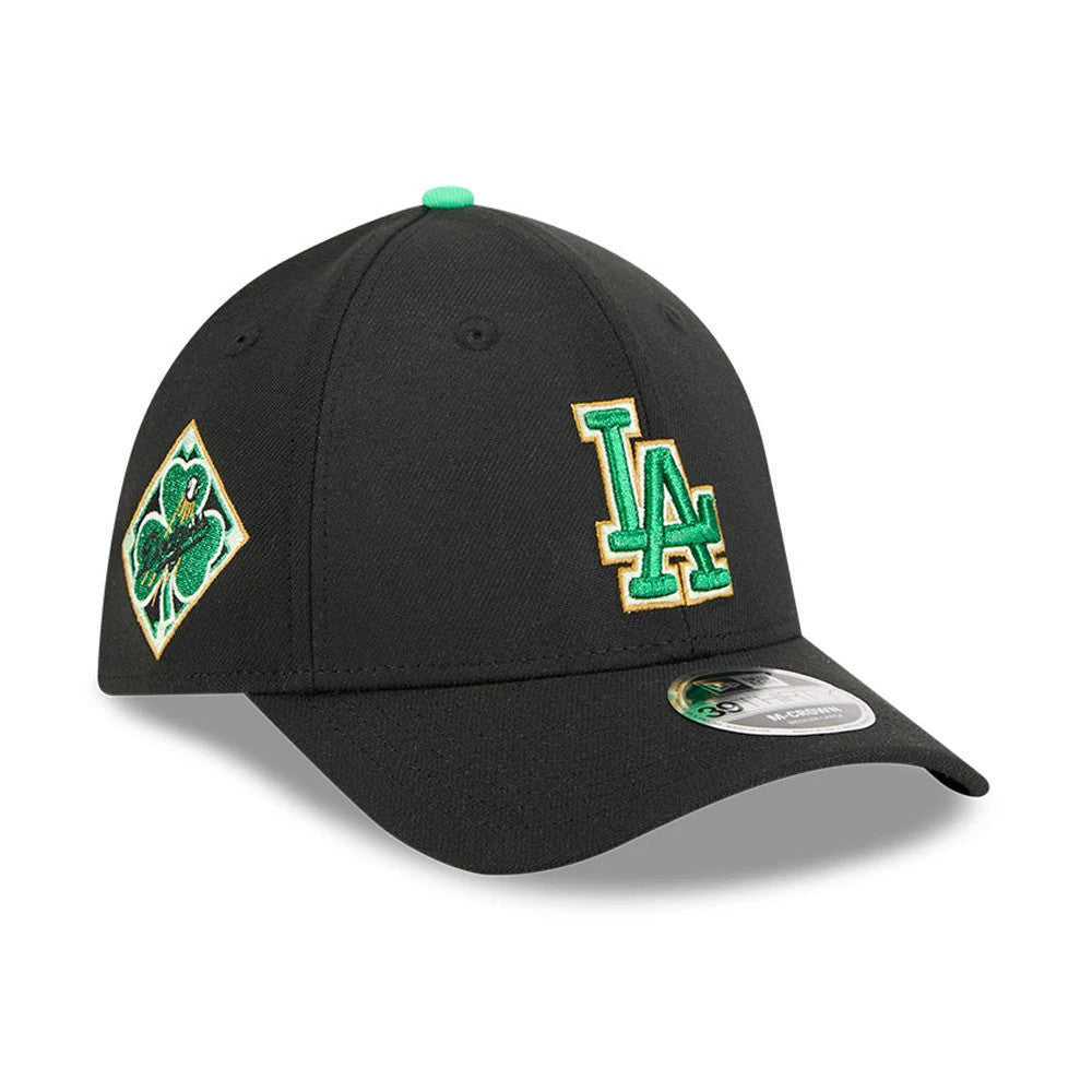 Dodgers MLB Saint Patrick's Day Black New Era 39THIRTY M-Crown A-Frame Stretch Fit Cap, three-quarter view showing a green and gold embroidered LA logo on the front panel, a green clover patch on the side.