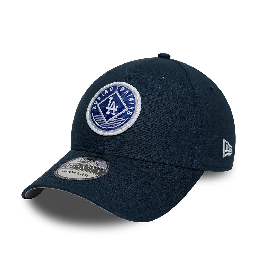 LA Dodgers MLB Ripstop Dark Blue New Era 39THIRTY Stretch Fit Cap, three-quarter view showing the white and blue Spring Training patch on the front panel, dark blue curved visor with a 39THIRTY size sticker, and New Era flag logo on the left side.