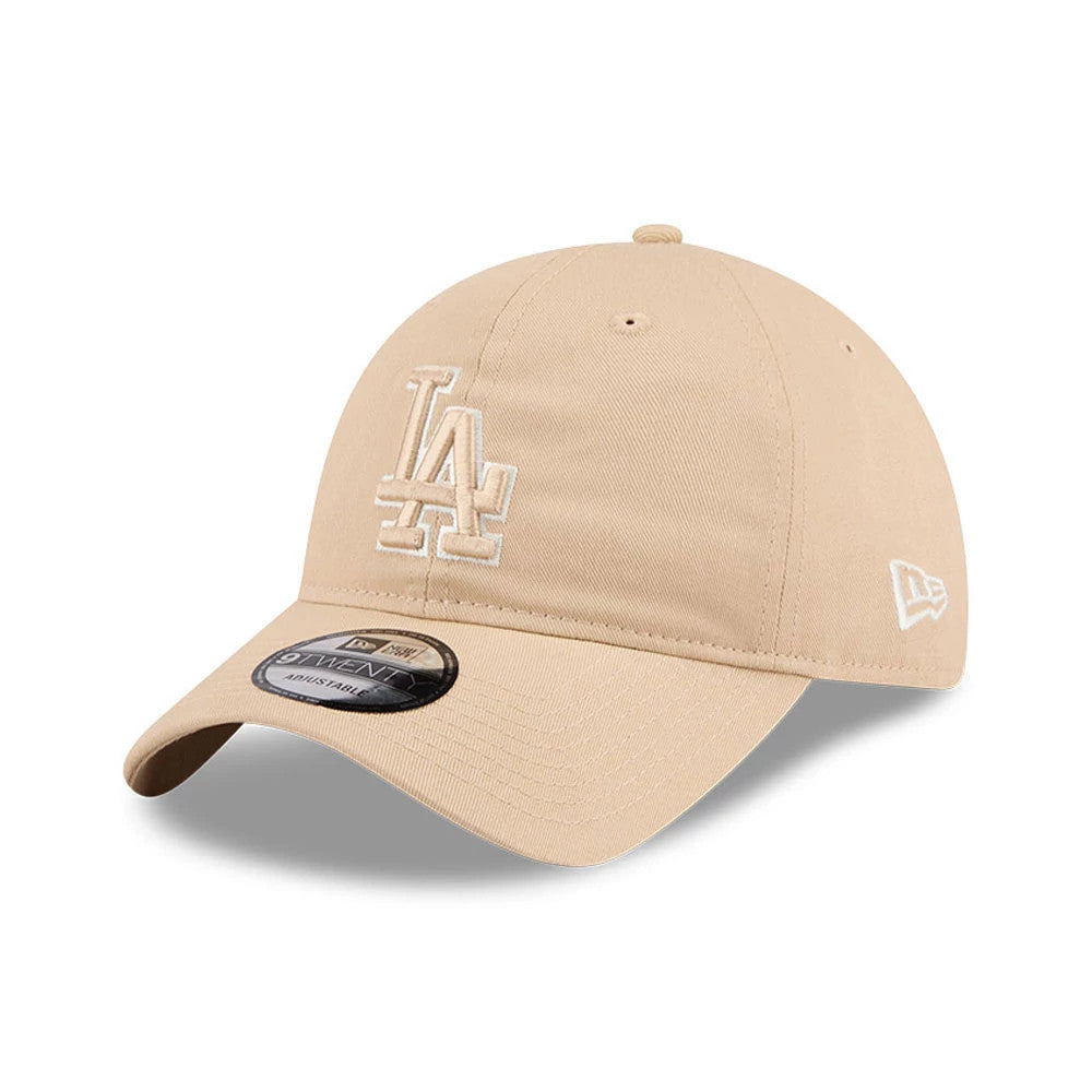 LA Dodgers MLB Colours Light Beige New Era 9TWENTY Adjustable Cap, three-quarter view showing the white embroidered LA logo on the front panel, a pre-curved visor with a 9TWENTY size sticker, and the New Era flag logo on the left side.