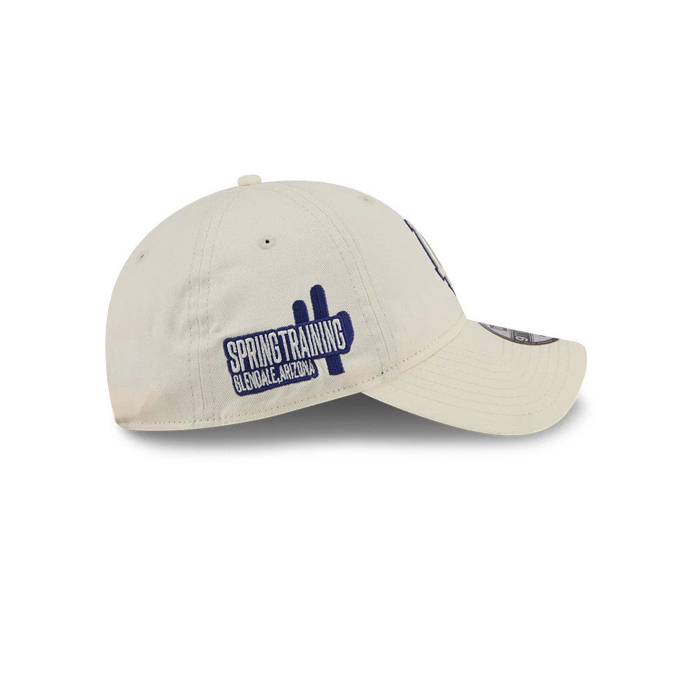 LA Dodgers MLB Colours White New Era 9TWENTY Adjustable Cap, side view showing a blue embroidered Spring Training Glendale, Arizona graphic on the unstructured white crown, with a curved visor and 9TWENTY size sticker.