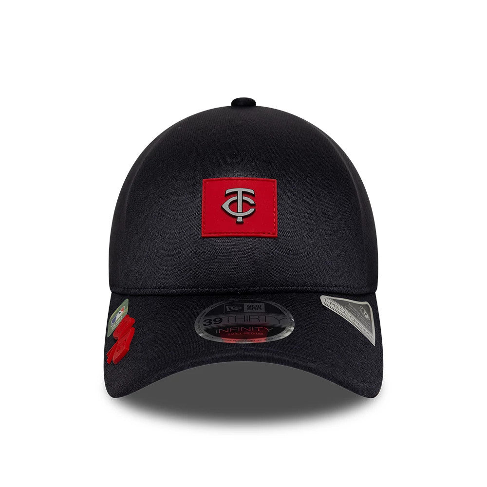 Minnesota Twins MLB Clubhouse Navy New Era 39THIRTY Infinity Stretch Fit Cap, front view showing a red team logo patch on the structured crown with a curved visor displaying a 39THIRTY size sticker.