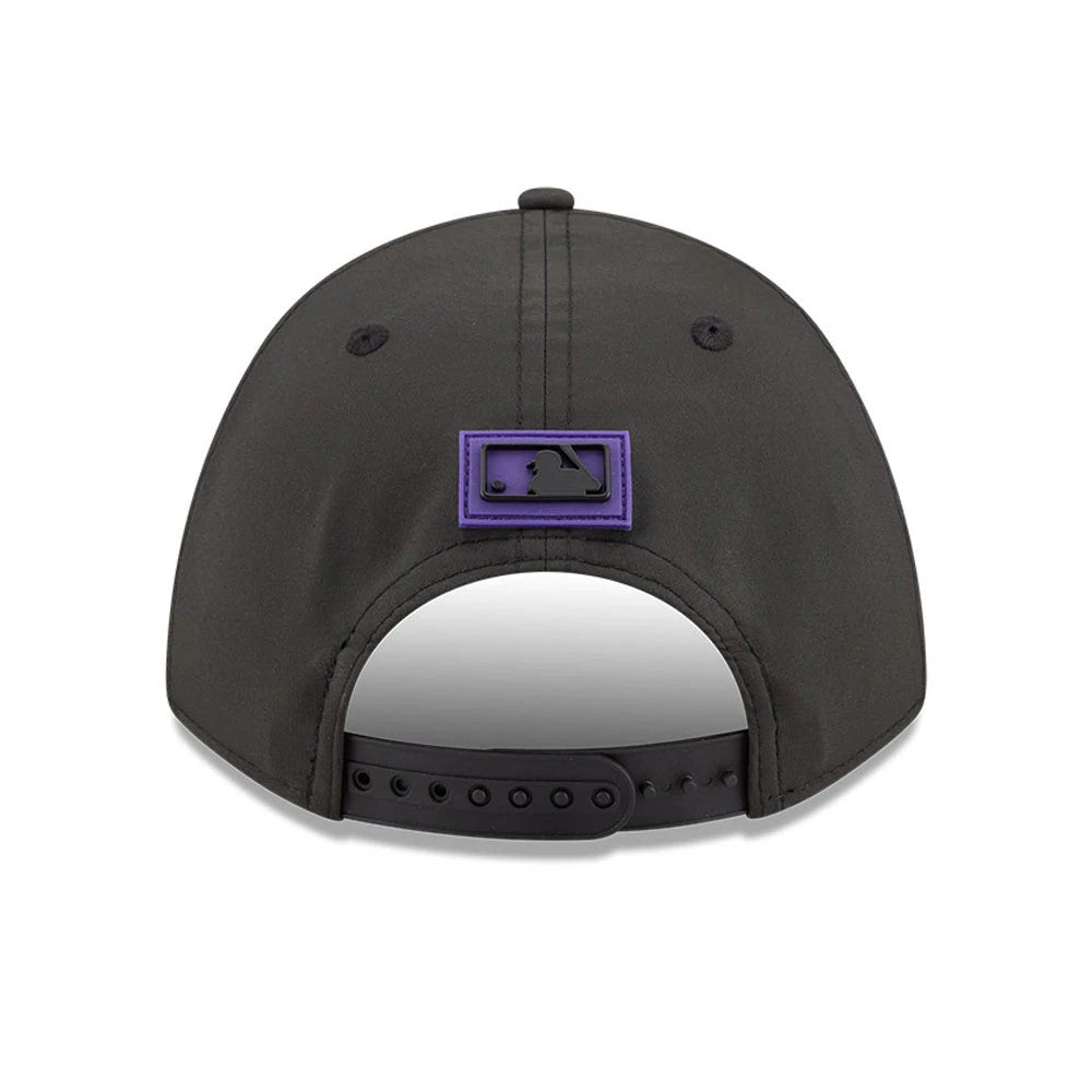 Colorado Rockies MLB Clubhouse Black New Era 9FORTY M-Crown A-Frame Adjustable Cap, rear view showing the black MLB Batterman logo with a purple border at the centre, featuring a curved black visor and an adjustable strap.