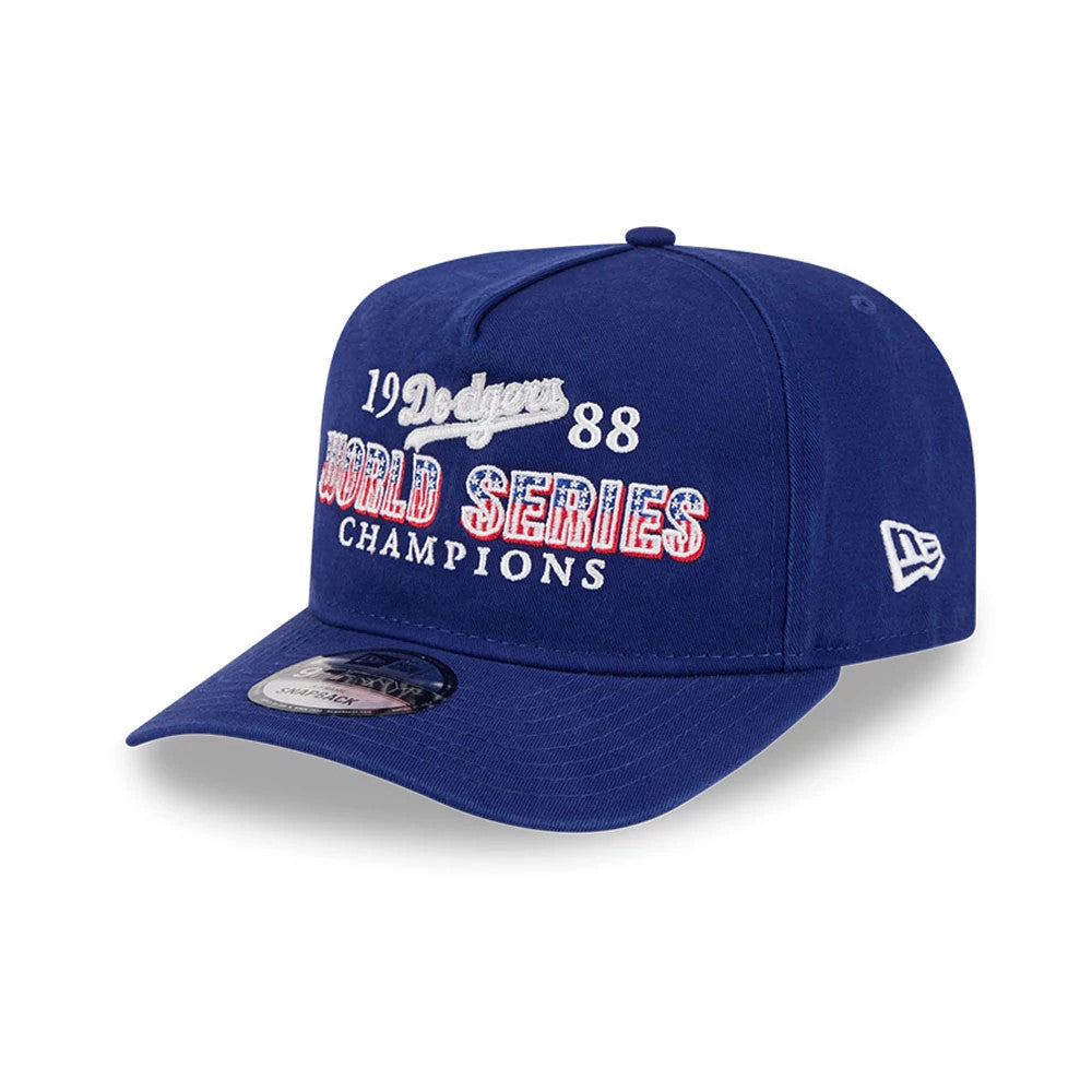 LA Dodgers MLB Historic Navy New Era 9FIFTY A-Frame Snapback Adjustable Cap, three-quarter view featuring white and red embroidered World Series Champions lettering on the structured navy crown, with a grey undervisor.