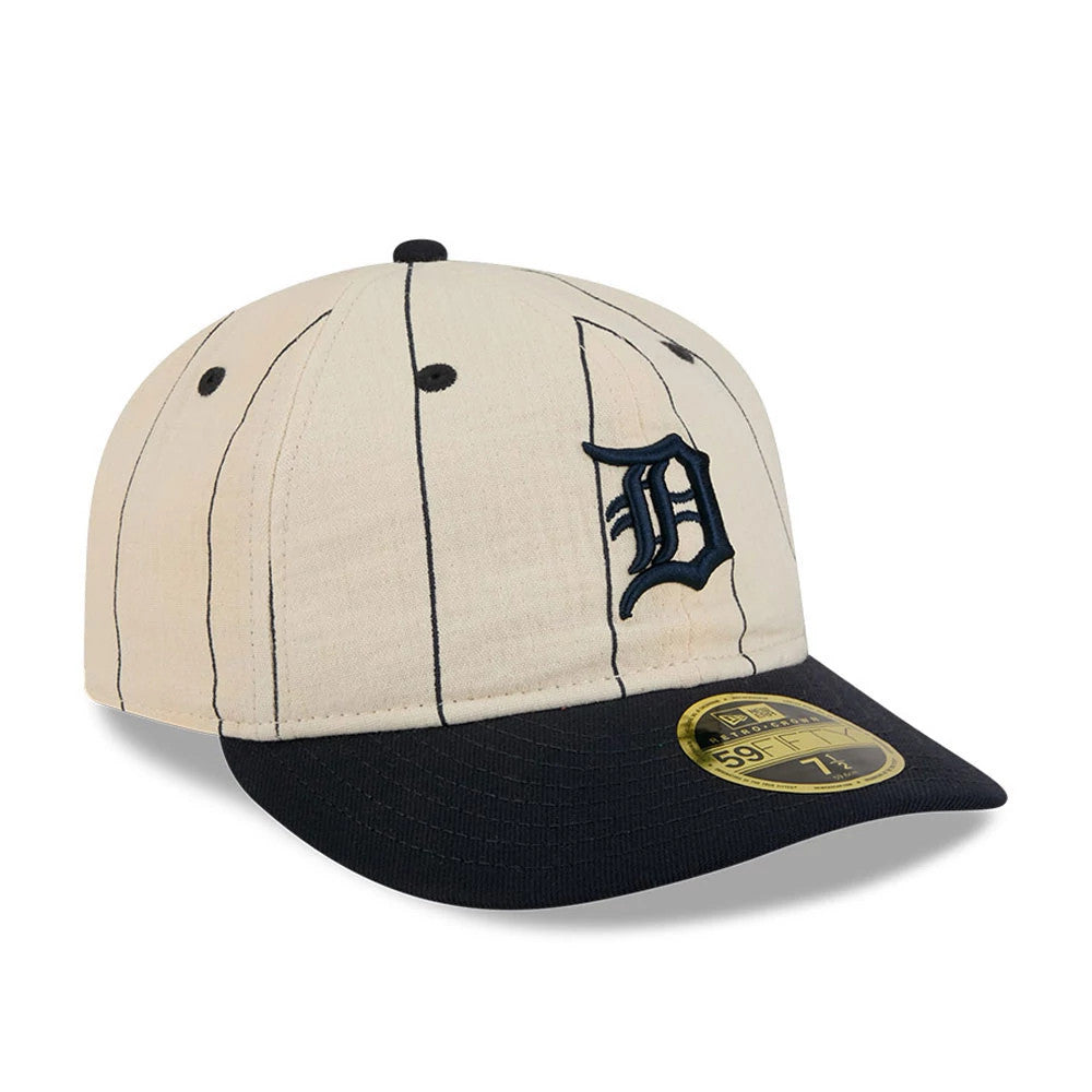 Detroit Tigers MLB Linen Cream Retro Crown New Era 59FIFTY Fitted Cap, three-quarter view showing the navy embroidered D logo on the front panel, with thin black pinstripes, a dark navy visor and a gold 59FIFTY size sticker.