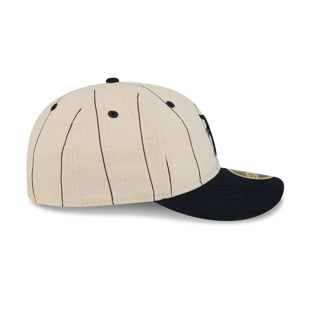 Detroit Tigers MLB Linen Cream Retro Crown New Era 59FIFTY Fitted Cap, side view with vertical navy pinstripes, black eyelets, a black flat visor, and gold 59FIFTY size sticker on the top edge.
