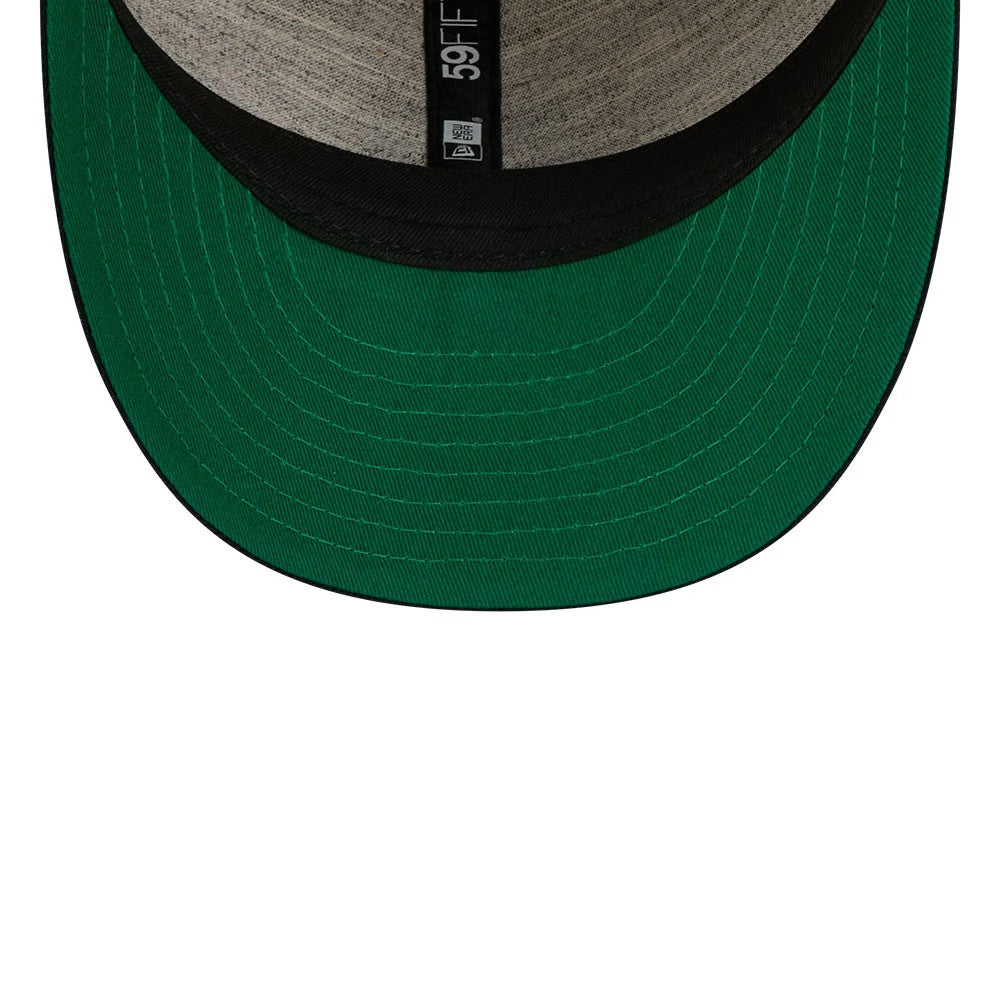 New York Yankees MLB Linen Cream Retro Crown New Era 59FIFTY Fitted Cap, inside view showing the green undervisor and grey taping with 59FIFTY branding, featuring a black sweatband enhancing the cap's structure.