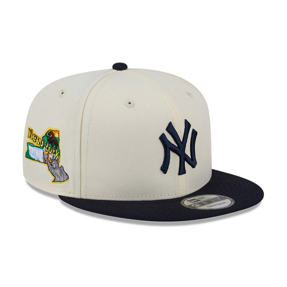 New York Yankees MLB Localized White New Era 9FIFTY Snapback Adjustable Cap, three-quarter view showing the navy embroidered Yankees logo on the front panel and an embroidered New York state graphic on the side, with a flat navy visor.