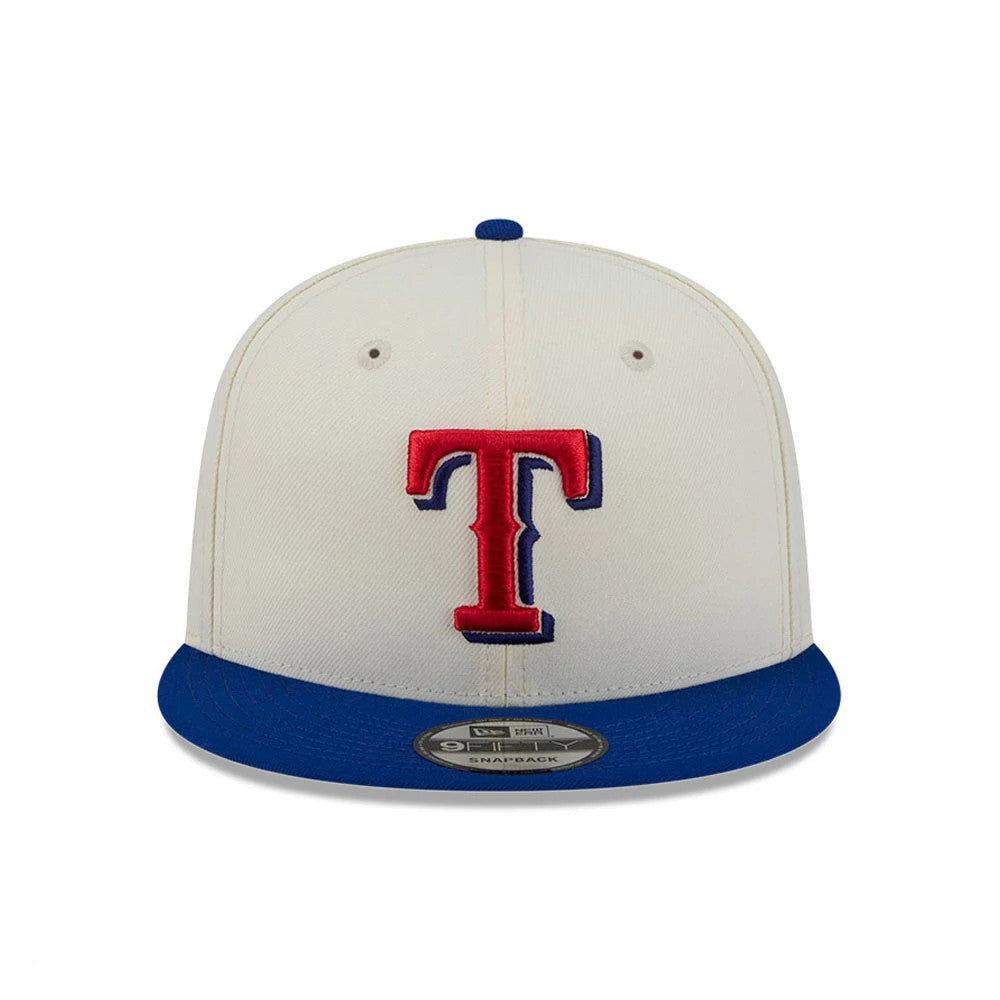 Texas Rangers MLB Localized White New Era 9FIFTY Snapback Adjustable Cap, front view showing the raised red embroidered T logo with blue outline on the white front panel, blue flat visor, and a 9FIFTY size sticker on the visor.