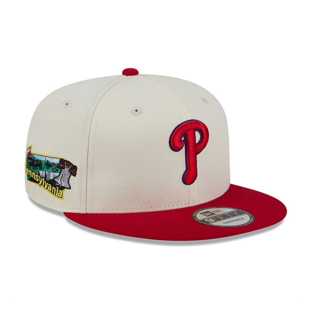 Philadelphia Phillies MLB Localized White New Era 9FIFTY Snapback Adjustable Cap, three-quarter view showing a raised red embroidered P logo on the front panel, a white crown with a Pennsylvania patch on the side.