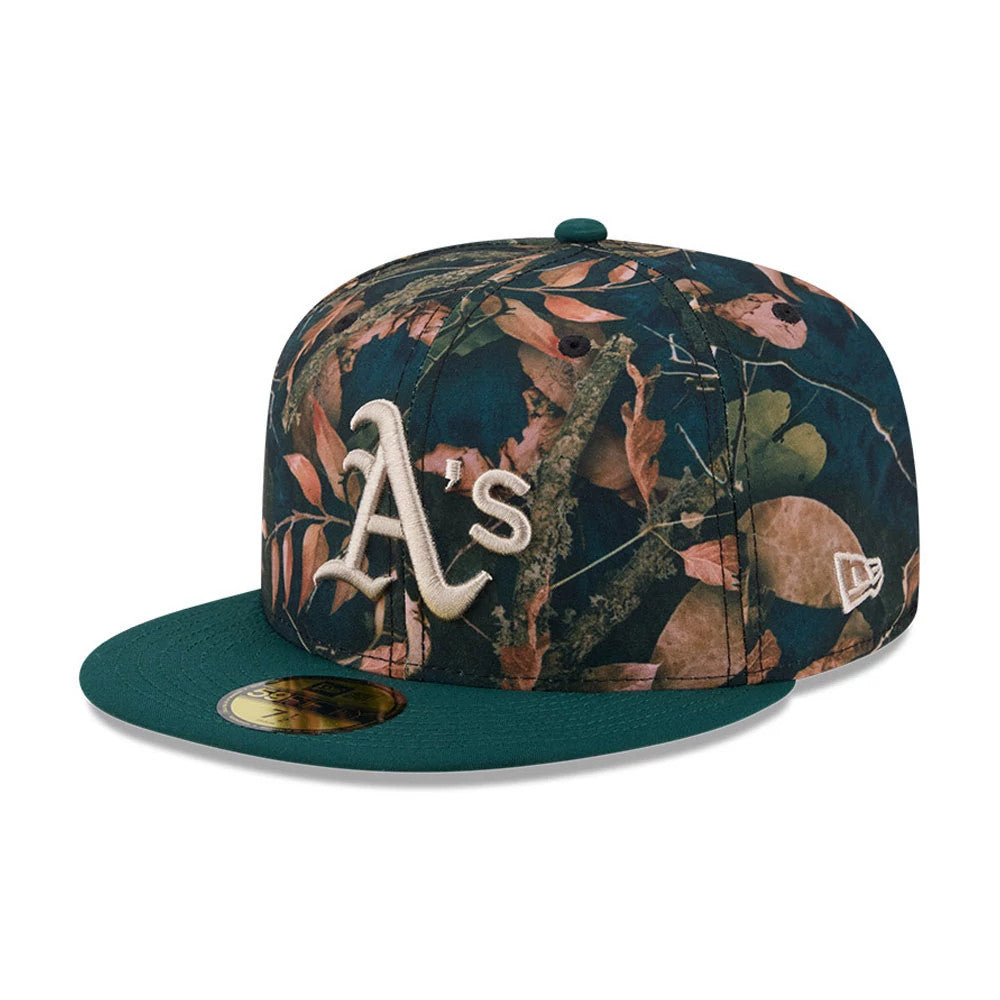 Athletics MLB Leaves Dark Green New Era 59FIFTY Fitted Cap, front view showing the raised white embroidered A's logo on the structured leaves-patterned crown, with a dark green flat visor and gold 59FIFTY size sticker.