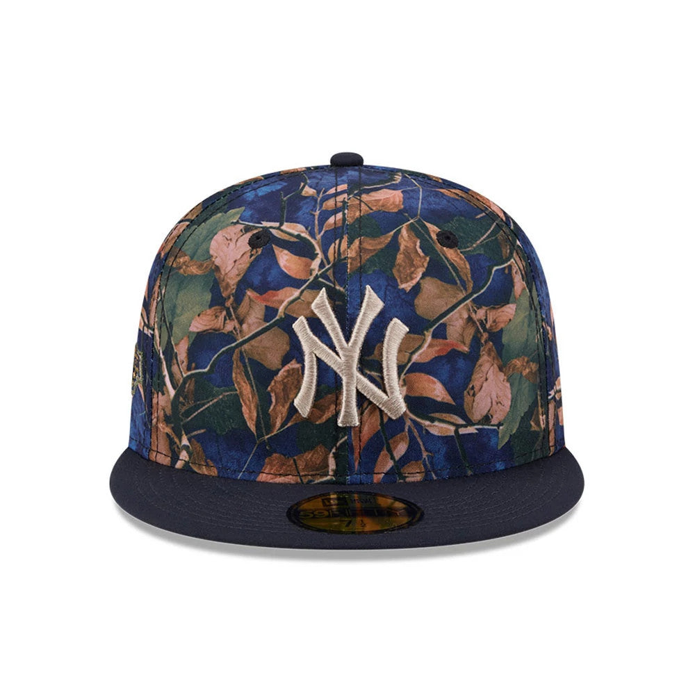 New York Yankees MLB Leaves Navy New Era 59FIFTY Fitted Cap, front view showing the raised embroidered white NY logo on a leafy patterned crown with a navy blue visor and a gold 59FIFTY size sticker.