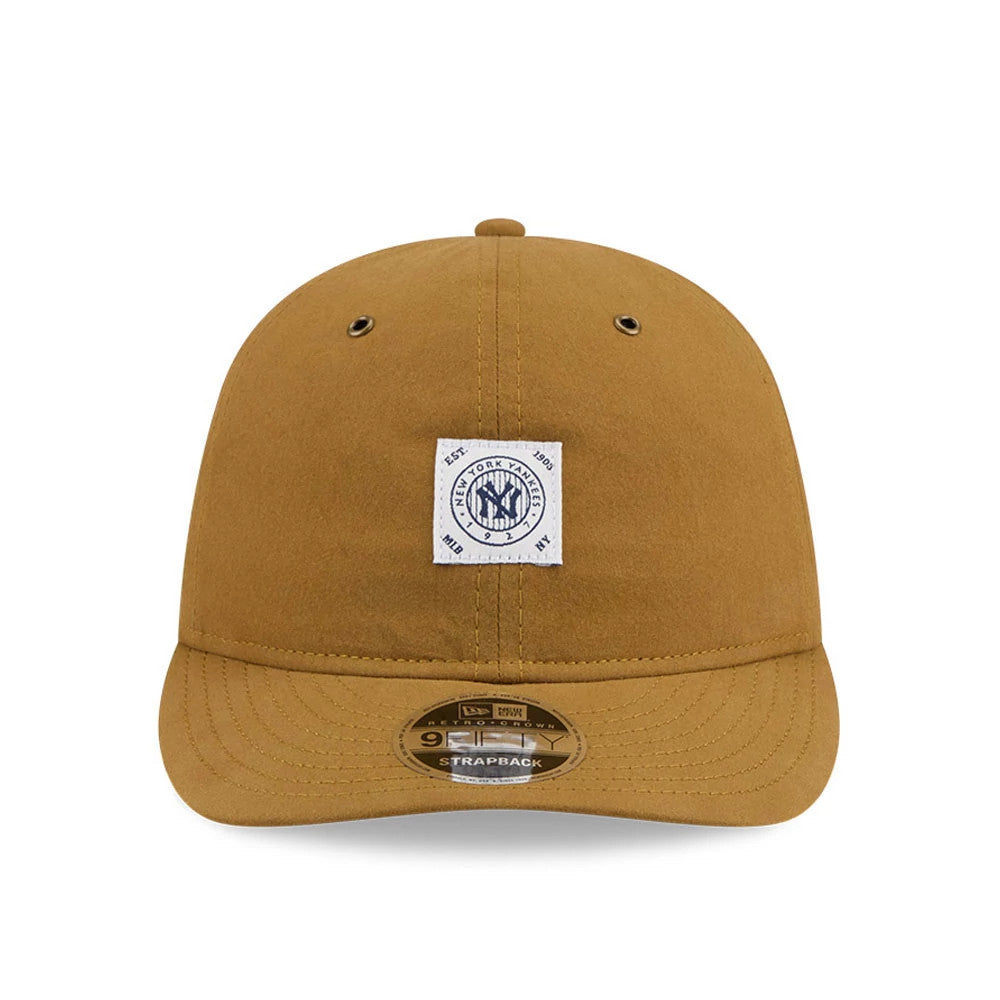 New York Yankees MLB Brushed Dark Beige Retro Crown New Era 9FIFTY Adjustable Cap, front view showing a white square patch with the Yankees logo on the crown, two black eyelets, and a 9FIFTY size sticker on the curved visor.