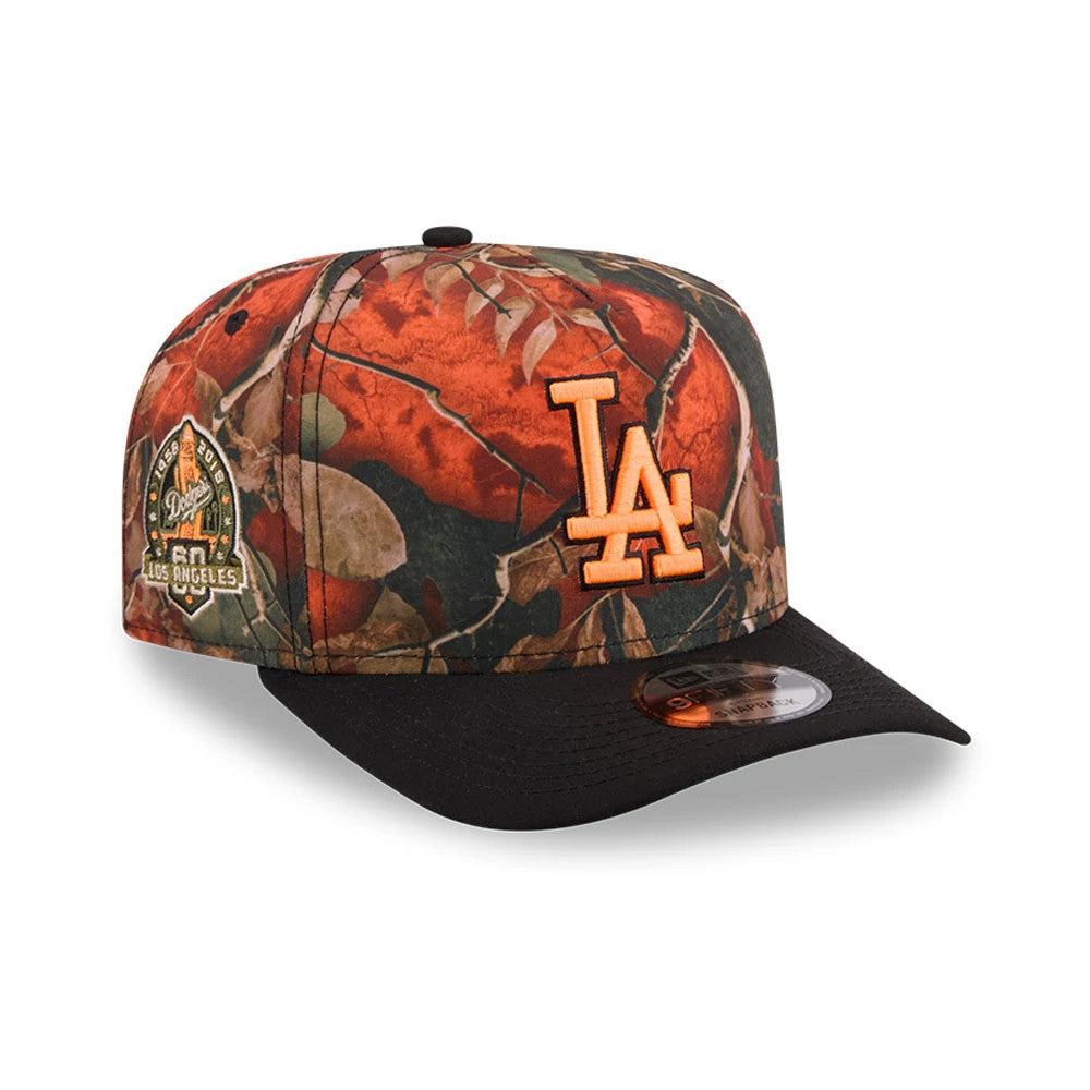 LA Dodgers MLB Leaves Bright Orange New Era 9FIFTY A-Frame Snapback Adjustable Cap, three-quarter view showing the raised orange LA logo on front panel, black flat visor with 9FIFTY size sticker, and a commemorative patch on the left side.