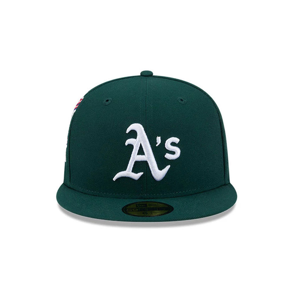 Athletics MLB Hidden Hit Dark Green New Era 59FIFTY Fitted Cap, front view showing a raised white embroidered A's logo on the structured dark green crown, complemented by a flat visor with a gold 59FIFTY size sticker.