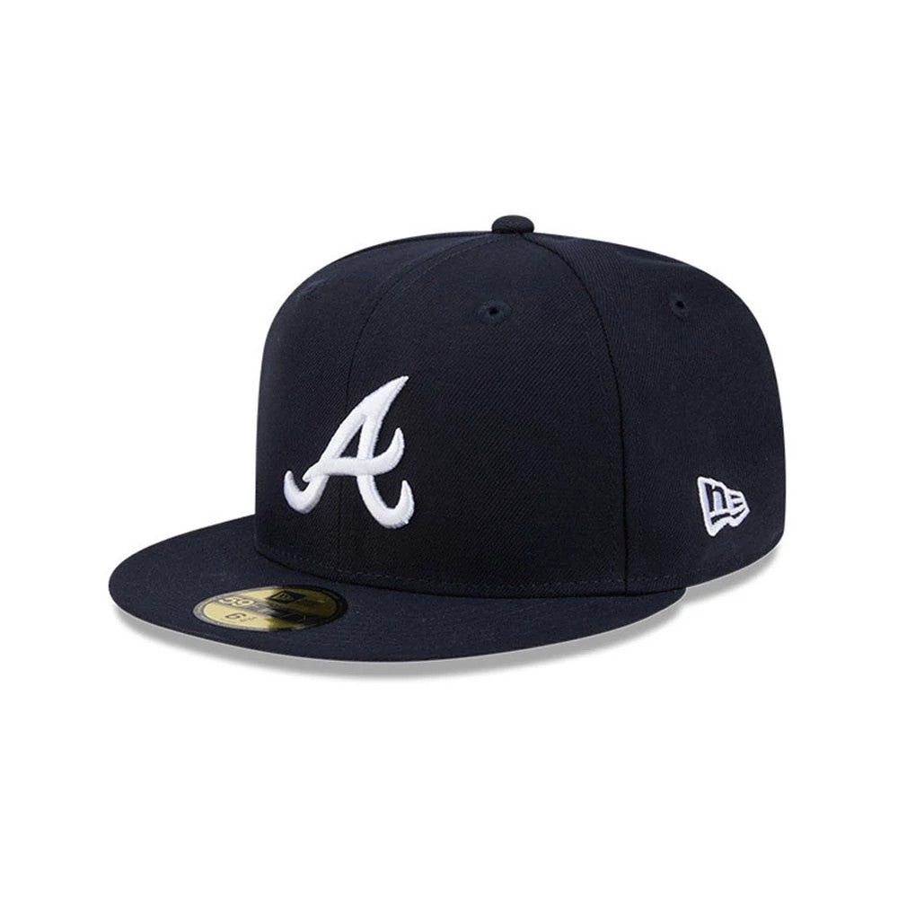 Atlanta Braves MLB Hidden Hit Navy New Era 59FIFTY Fitted Cap, three-quarter view showing the white embroidered A logo on the front panel, navy flat visor with a gold 59FIFTY size sticker, and New Era flag logo on the left side.