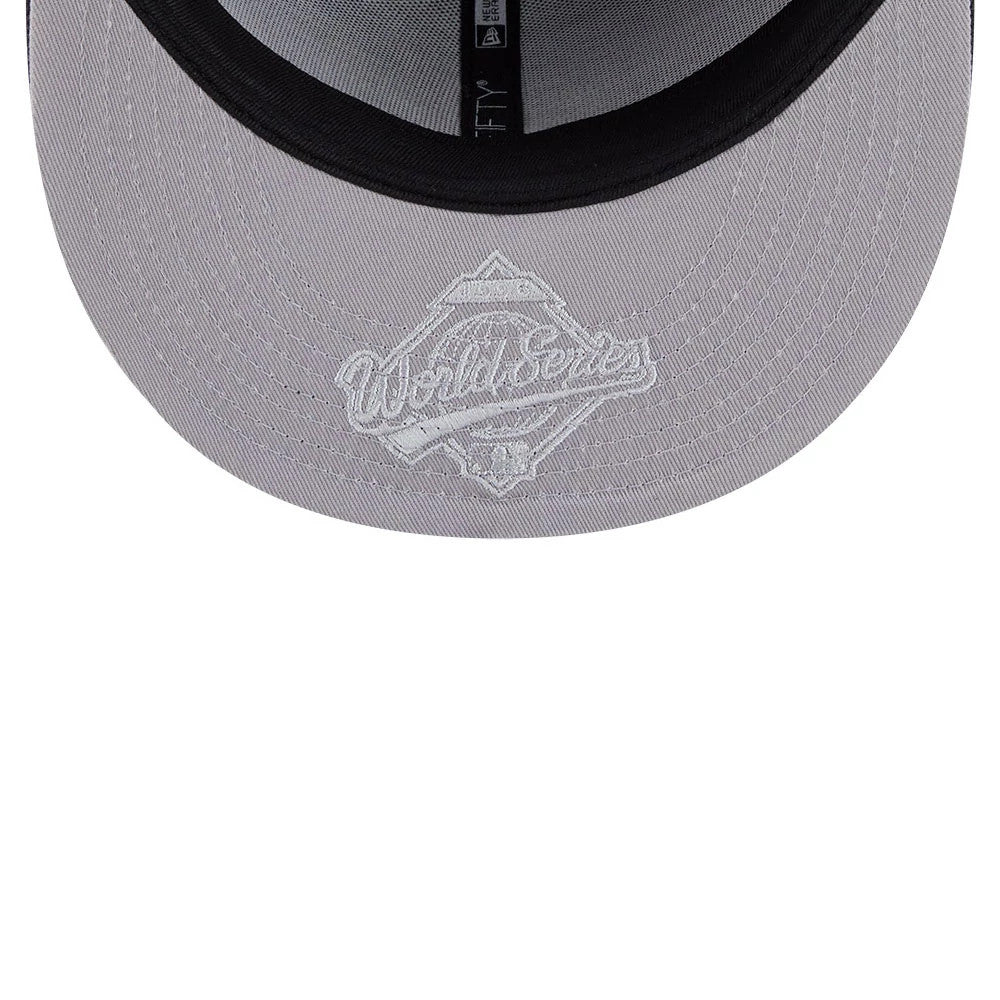 Atlanta Braves MLB Hidden Hit Navy New Era 59FIFTY Fitted Cap, inside view showing grey undervisor with white embroidered World Series graphic, black sweatband featuring the New Era logo, and contrasting grey interior taping.
