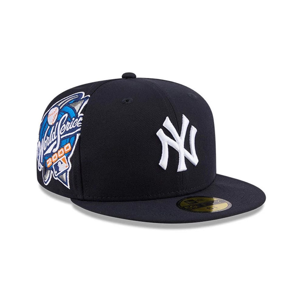 New York Yankees MLB Hidden Hit Navy New Era 59FIFTY Fitted Cap, three-quarter view showing the white raised embroidered NY logo on the front panel, with a World Series 2000 patch on the right side.