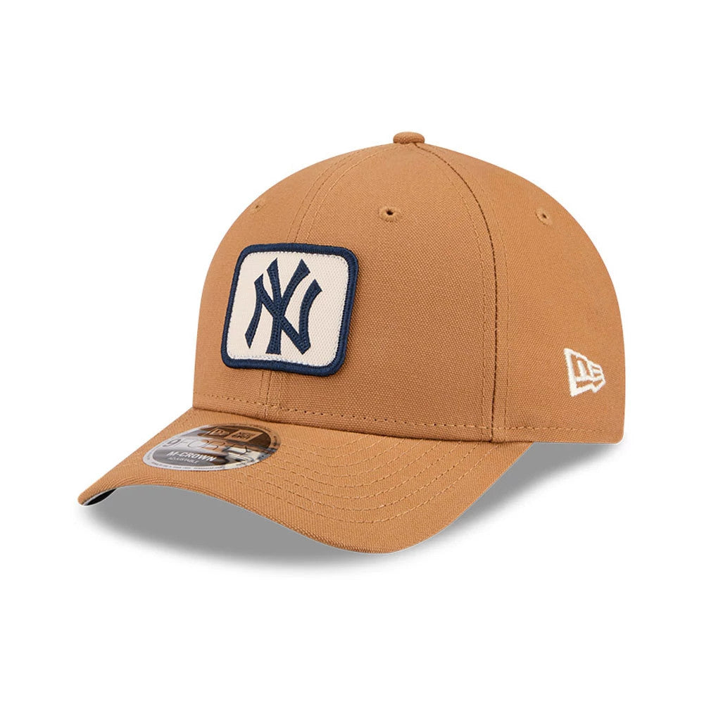 New York Yankees MLB Team Choice Beige New Era 9FORTY M-Crown Adjustable Cap, three-quarter view showing a navy embroidered NY logo on a white patch on the front panel, with a curved visor and a beige 9FORTY size sticker.
