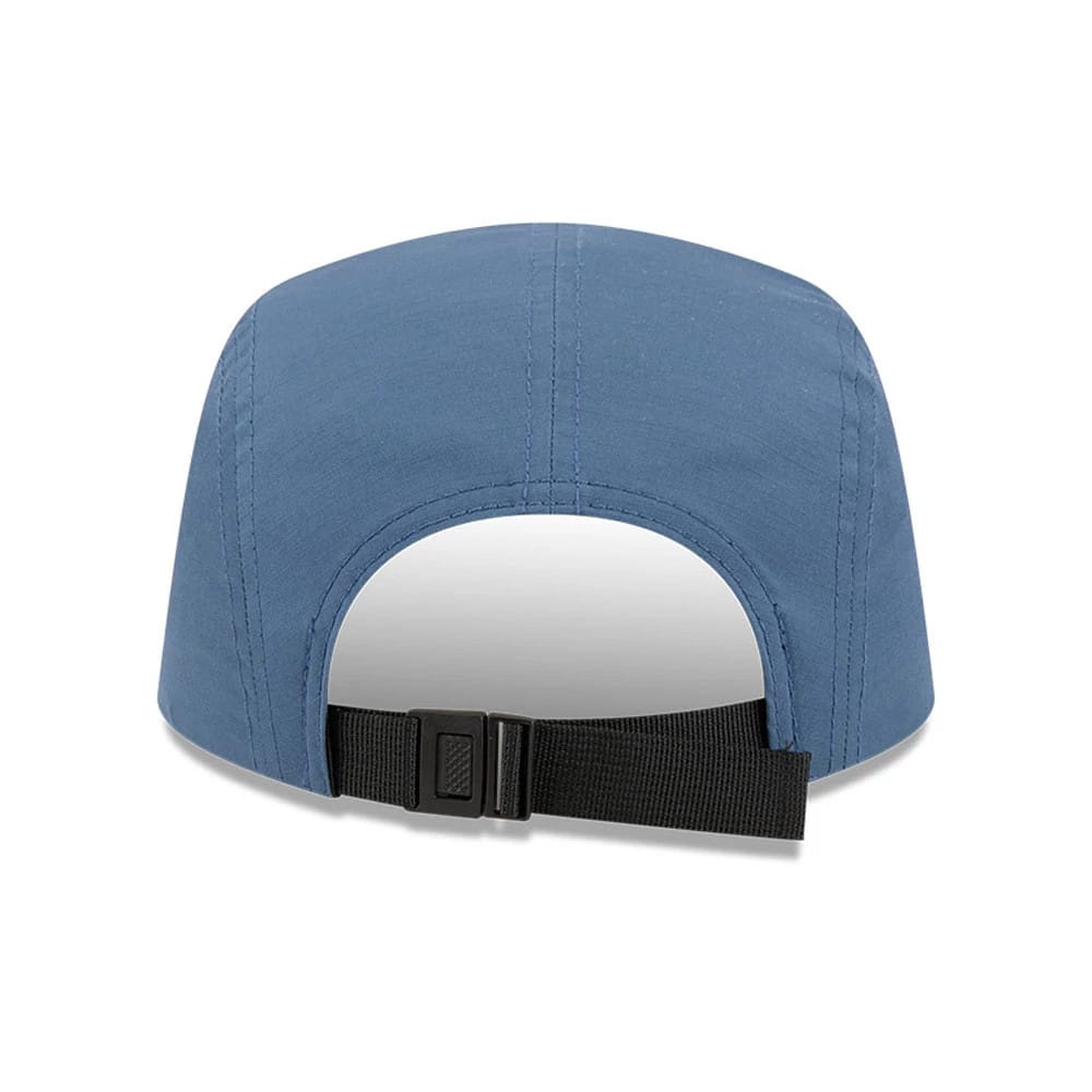 New Era The Goonies Astoria Warner Brothers Open Blue Camper Cap, rear view showing a black adjustable strap with buckle closure on the blue unstructured crown, highlighting neat stitching along the panels.