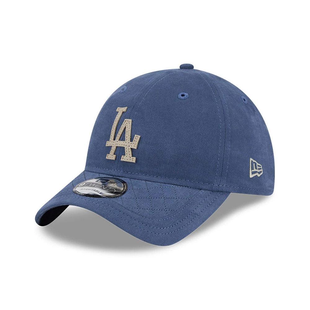 LA Dodgers MLB Quilted Dark Blue New Era 9TWENTY Adjustable Cap, three-quarter view showing a white embroidered LA logo on the front panel, with a quilted pattern on the curved visor and 9TWENTY size sticker, New Era flag logo on the left side.