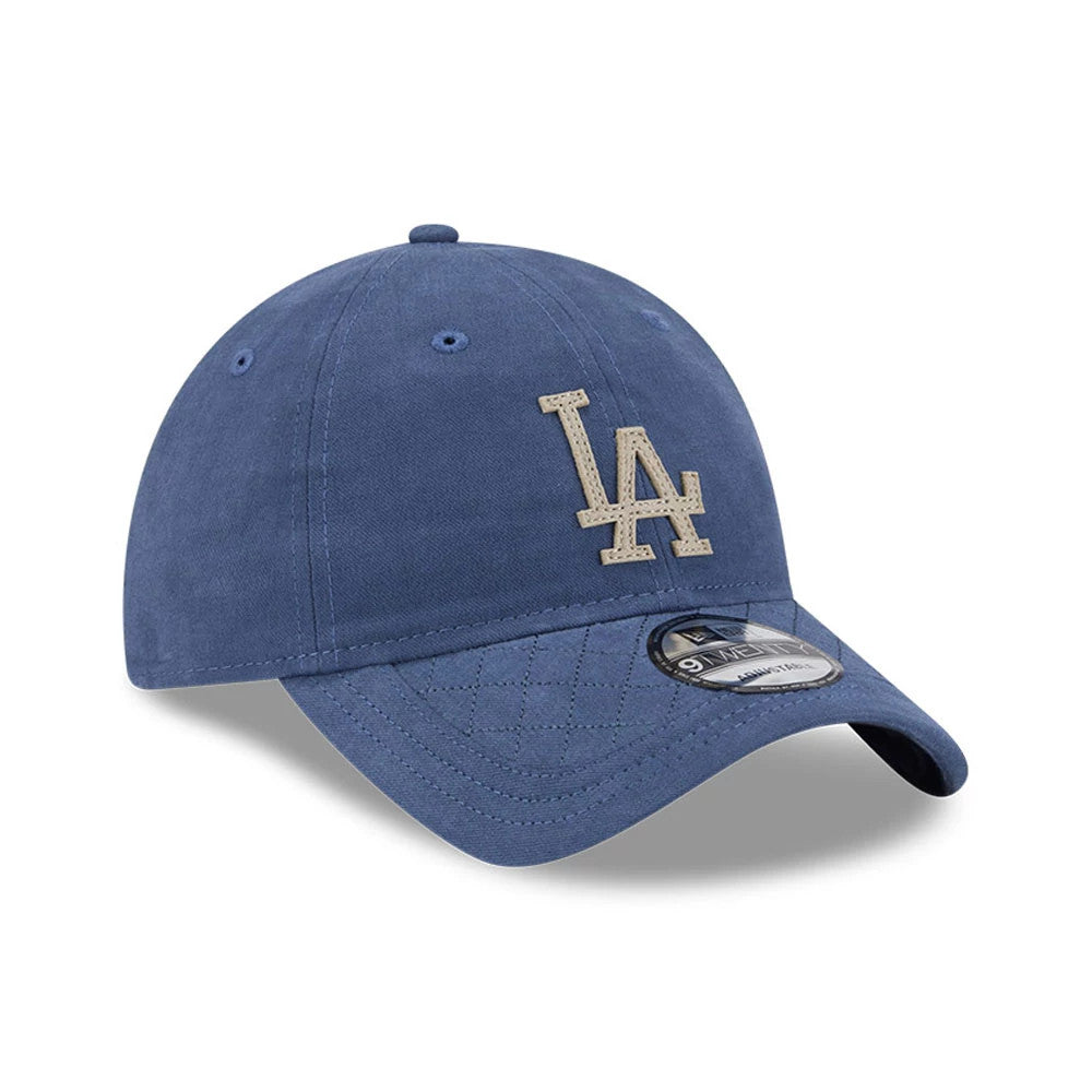 LA Dodgers MLB Quilted Dark Blue New Era 9TWENTY Adjustable Cap, front view showing a beige embroidered LA logo on the structured dark blue crown, with a 9TWENTY size sticker on the quilted curved visor.