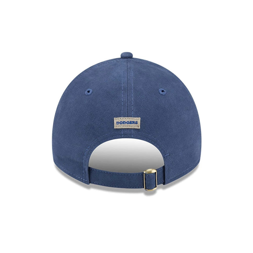 LA Dodgers MLB Quilted Dark Blue New Era 9TWENTY Adjustable Cap, rear view showing the Dodgers wordmark patch above the strap with a brass buckle, set on a dark blue quilted fabric crown with matching eyelets.