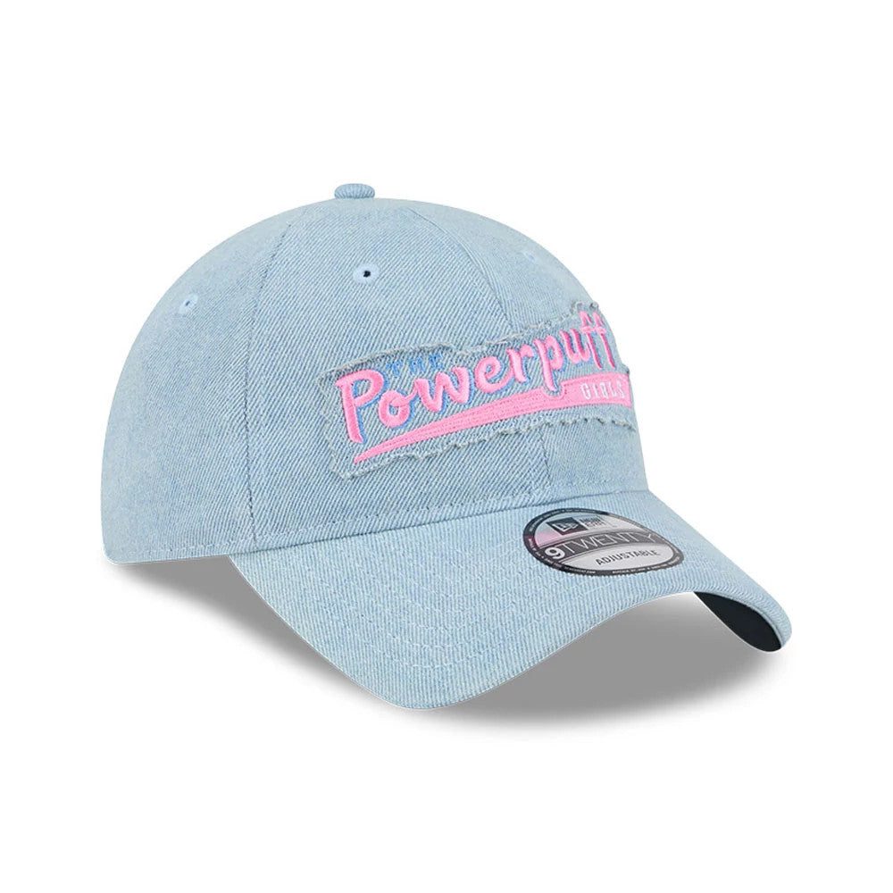 Power Puff Girls Wordmark Open Blue New Era 9TWENTY Adjustable Cap, three-quarter view showing pink embroidered logo on the front panel, light blue denim crown, curved visor, and 9TWENTY size sticker on the visor.