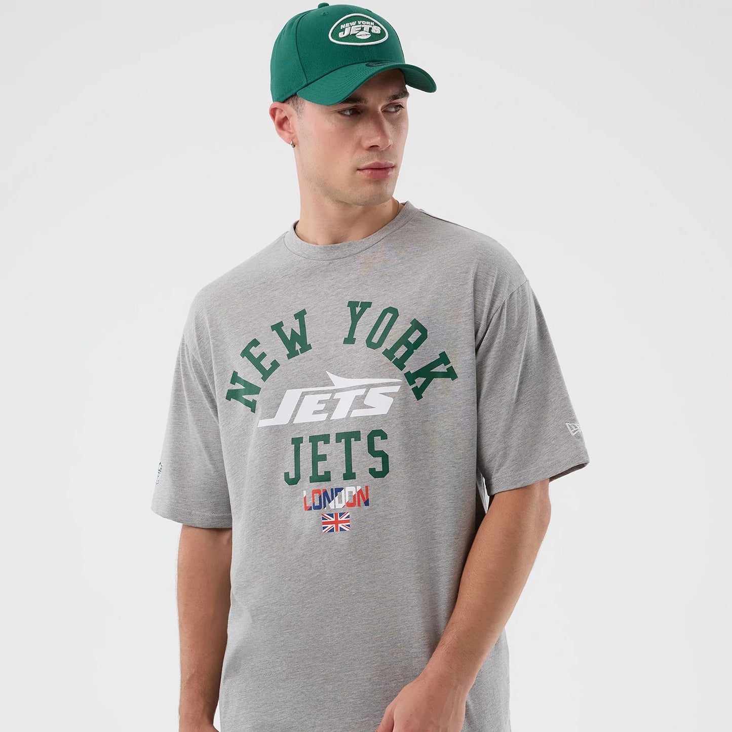 The Male model is wearing New York Jets NFL International Series Games Grey Oversized T-Shirt 7
