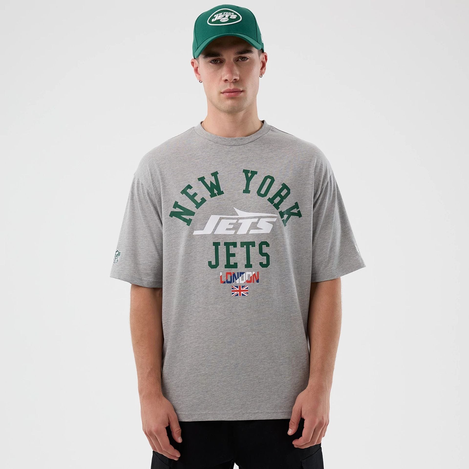 The Male model is wearing New York Jets NFL International Series Games Grey Oversized T-Shirt 1