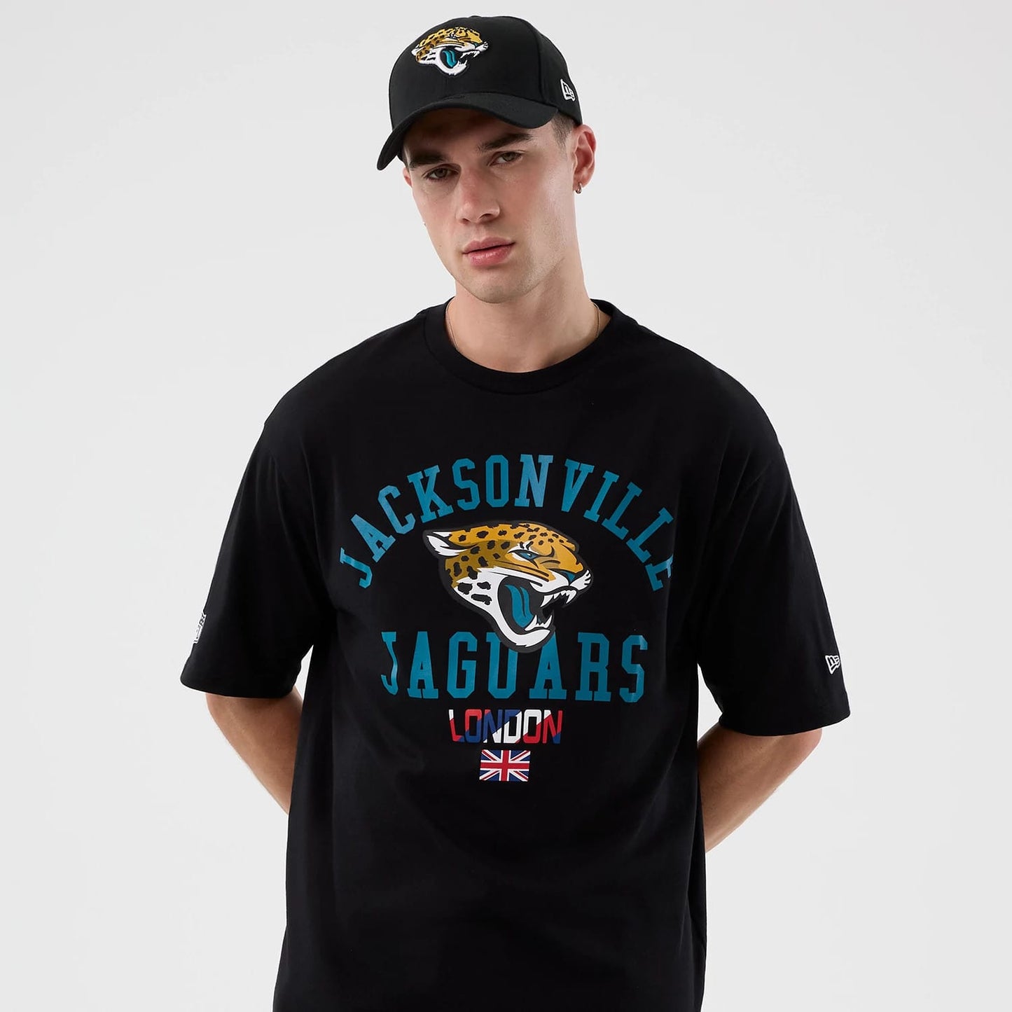 The Male model is wearing Jacksonville Jaguars NFL International Series Games Black Oversized T-Shirt 7