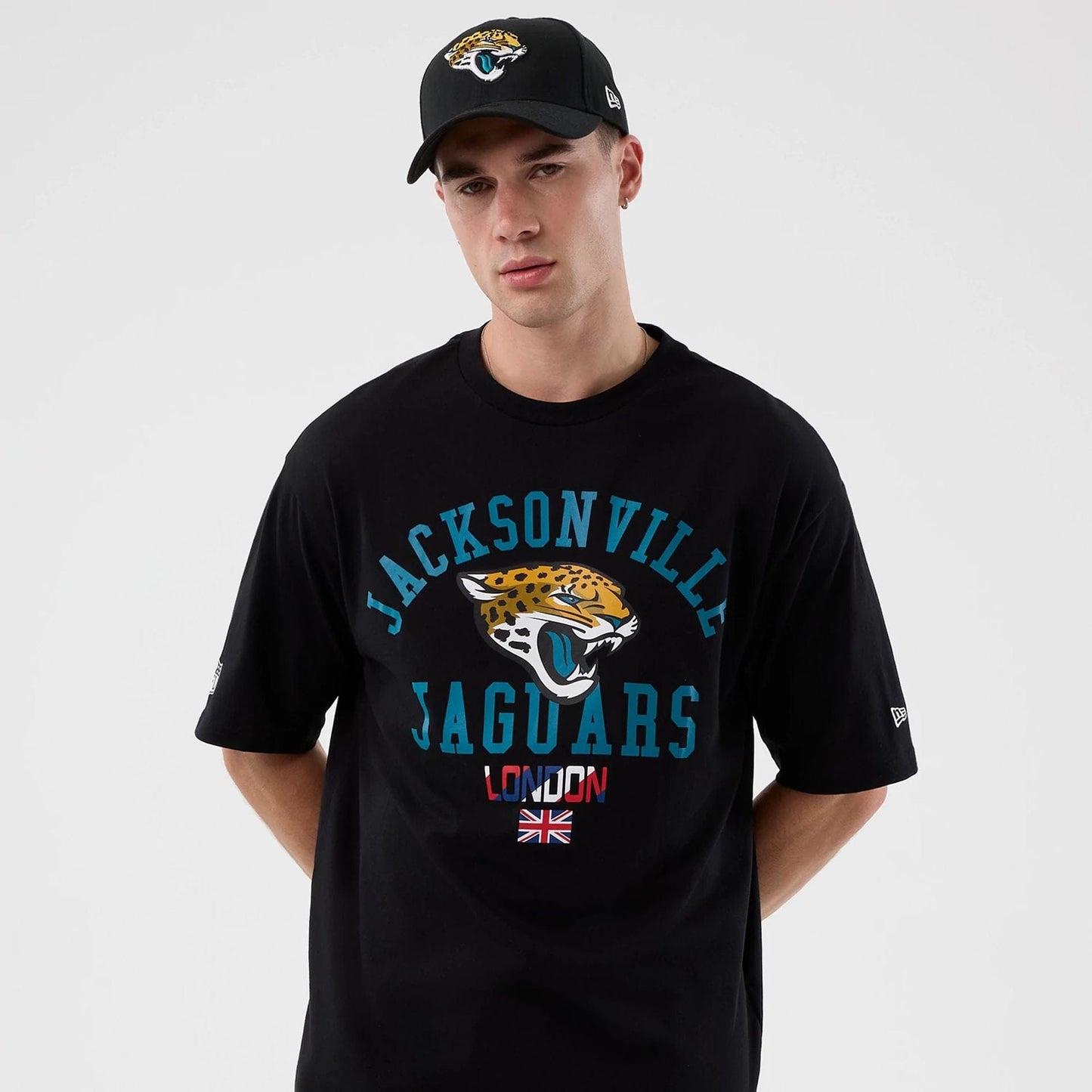 The Male model is wearing Jacksonville Jaguars NFL International Series Games Black Oversized T-Shirt 7