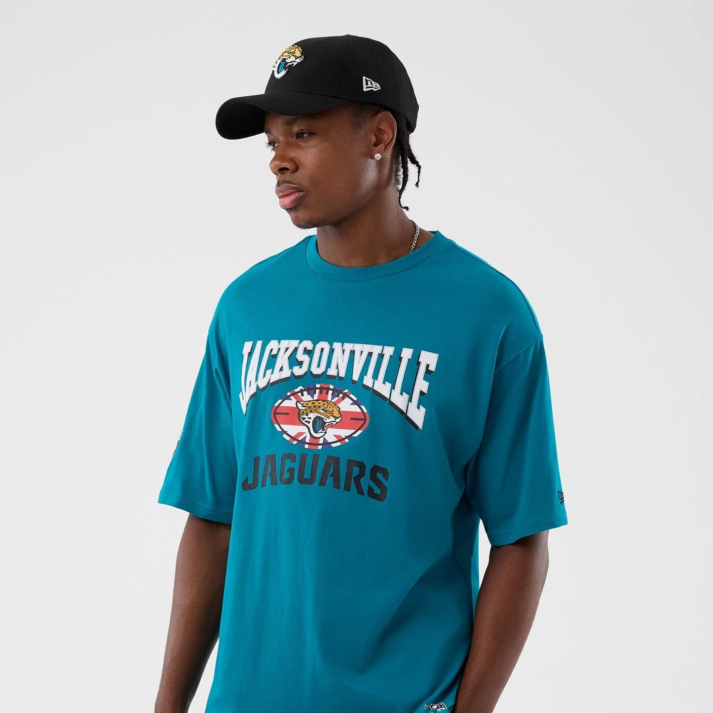 The Male model is wearing Jacksonville Jaguars NFL International Series Games Turquoise Oversized T-Shirt 7