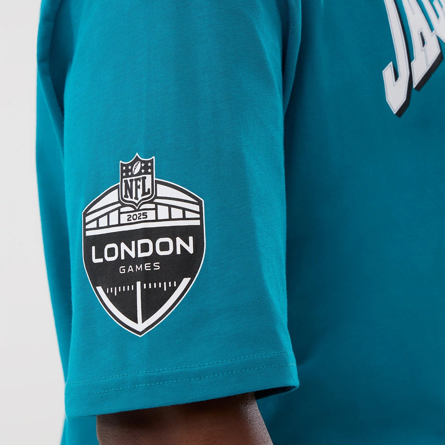 The Male model is wearing Jacksonville Jaguars NFL International Series Games Turquoise Oversized T-Shirt 3