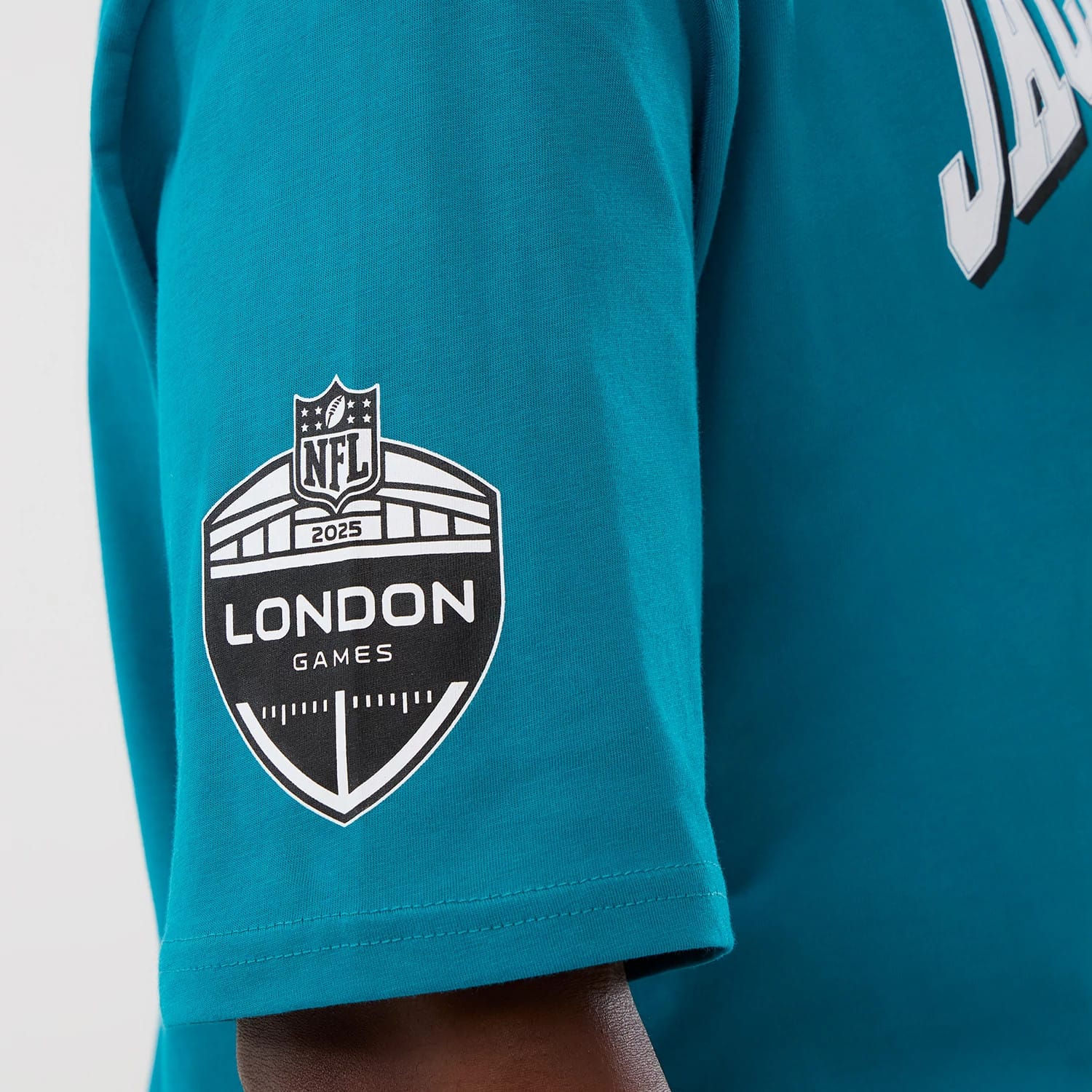 The Male model is wearing Jacksonville Jaguars NFL International Series Games Turquoise Oversized T-Shirt 3