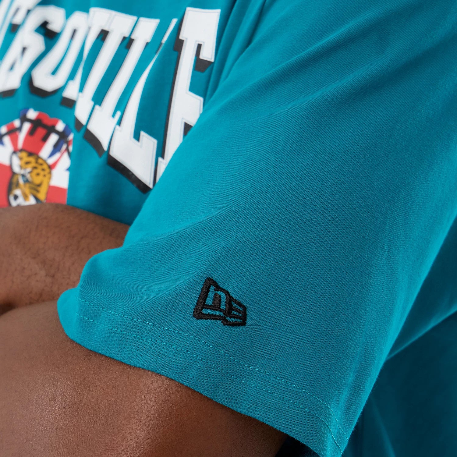 The Male model is wearing Jacksonville Jaguars NFL International Series Games Turquoise Oversized T-Shirt 4